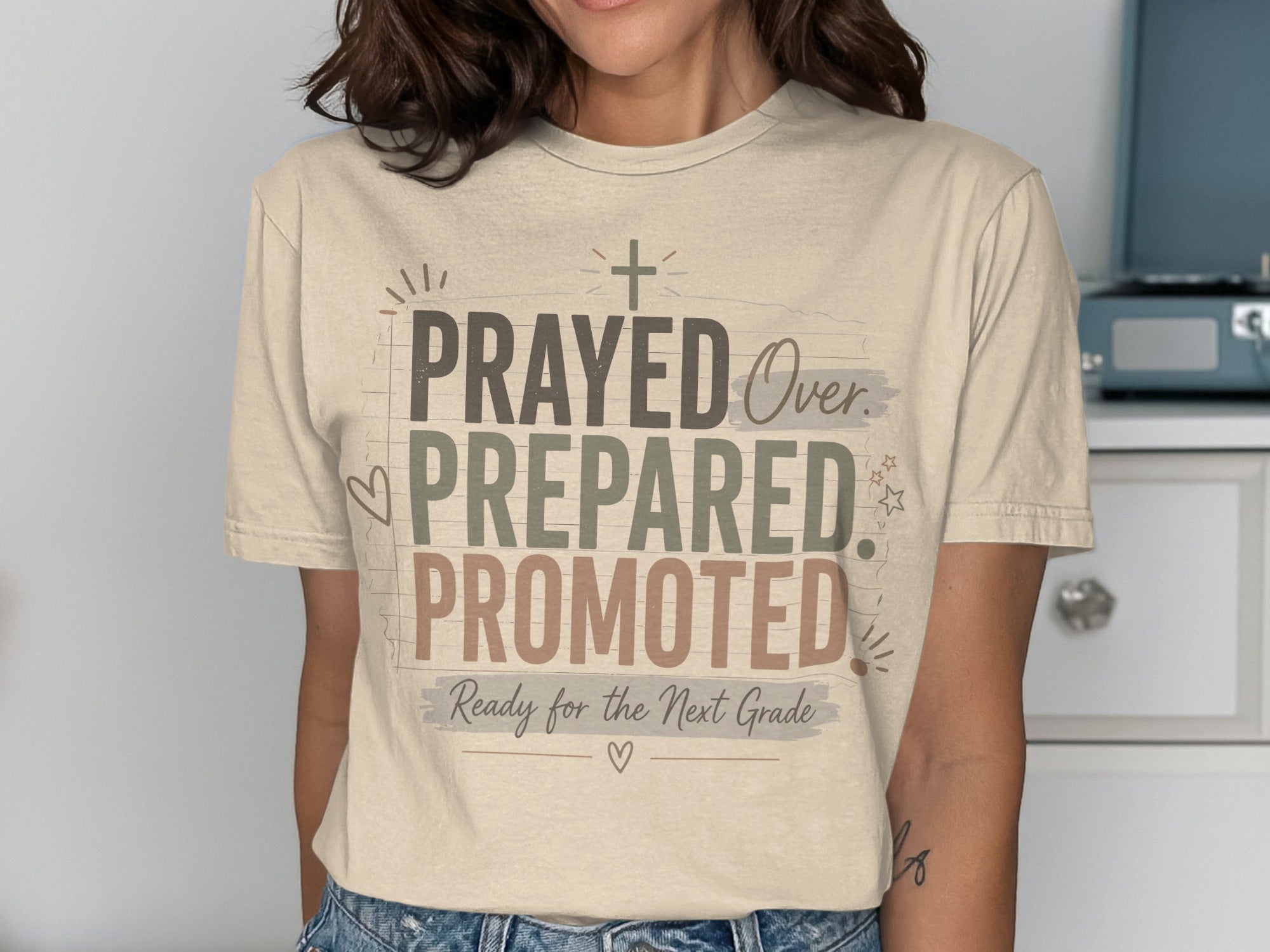 Beige t-shirt with "Prayed, Over, Prepared, Promoted" and "Ready for the Next Grade."