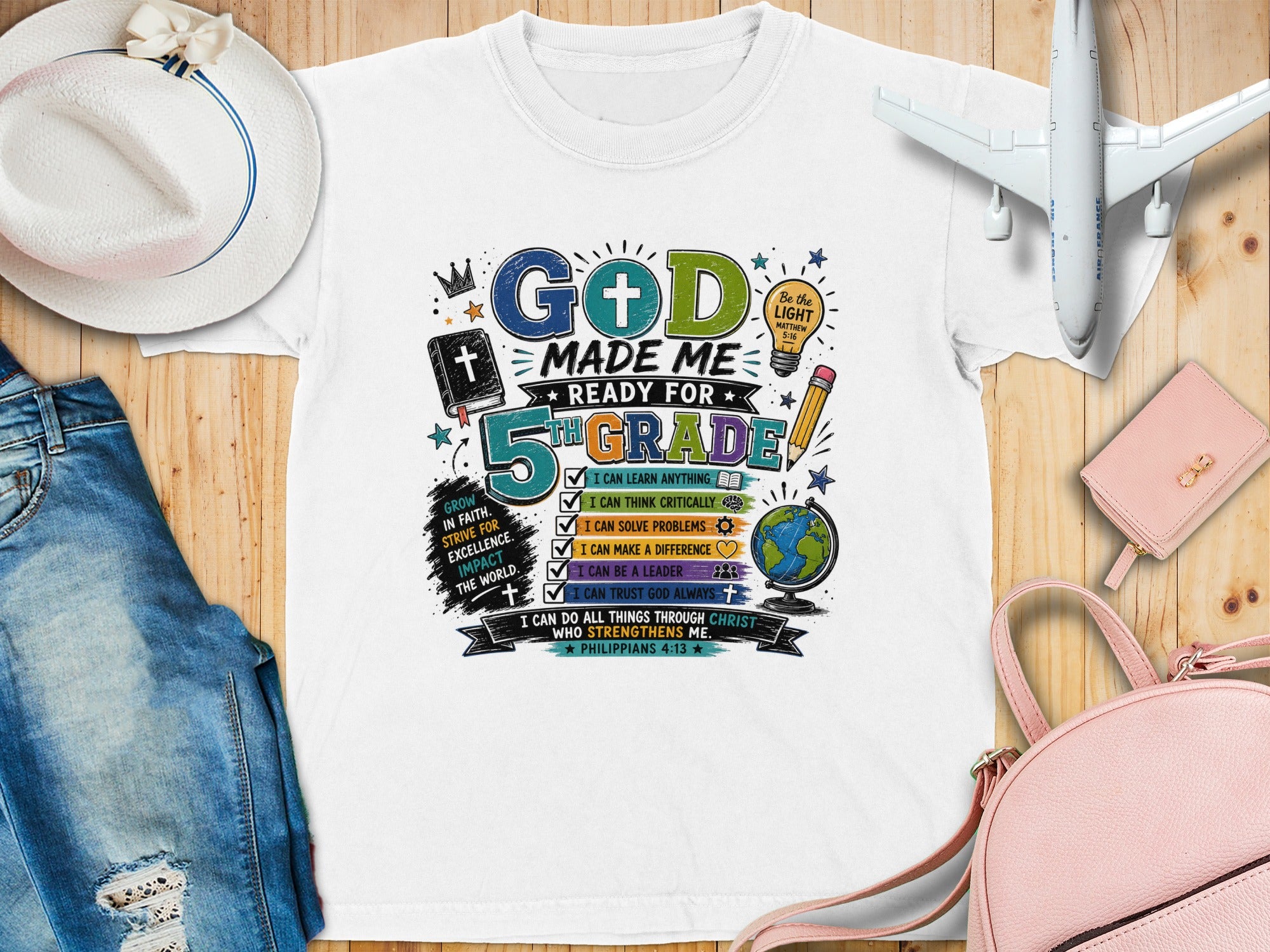 White t-shirt with "God Made Me Ready for 5th Grade" graphic and Bible verses.