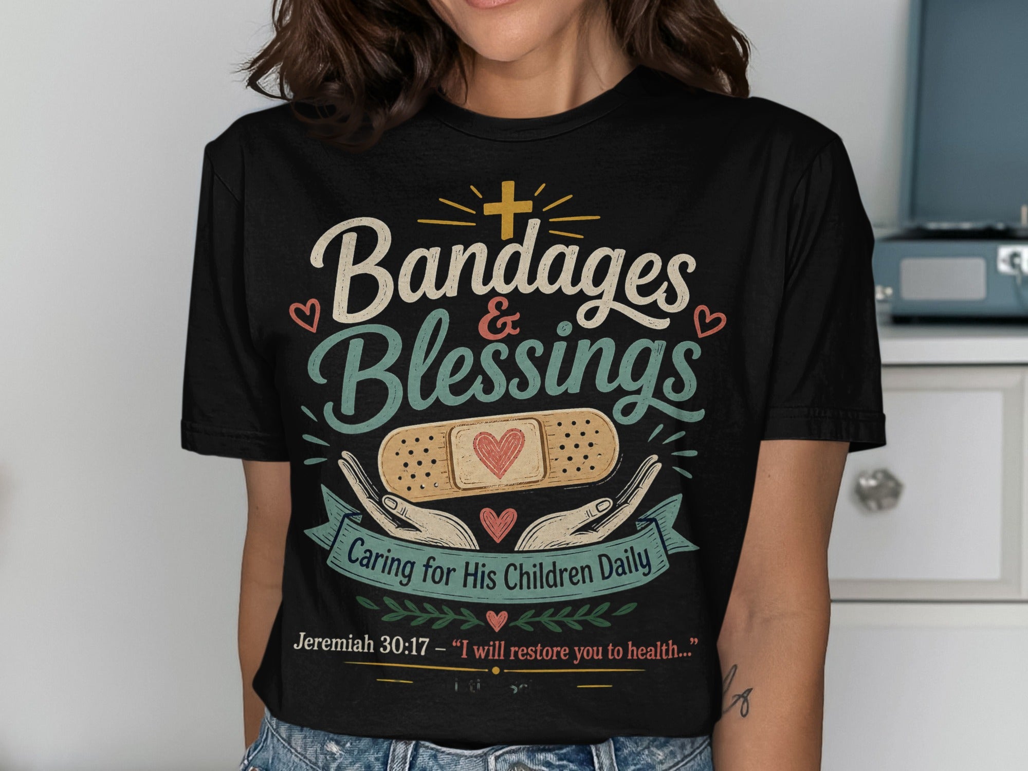 Black t-shirt with "Bandages & Blessings" and Jeremiah 30:17 Bible quote.
