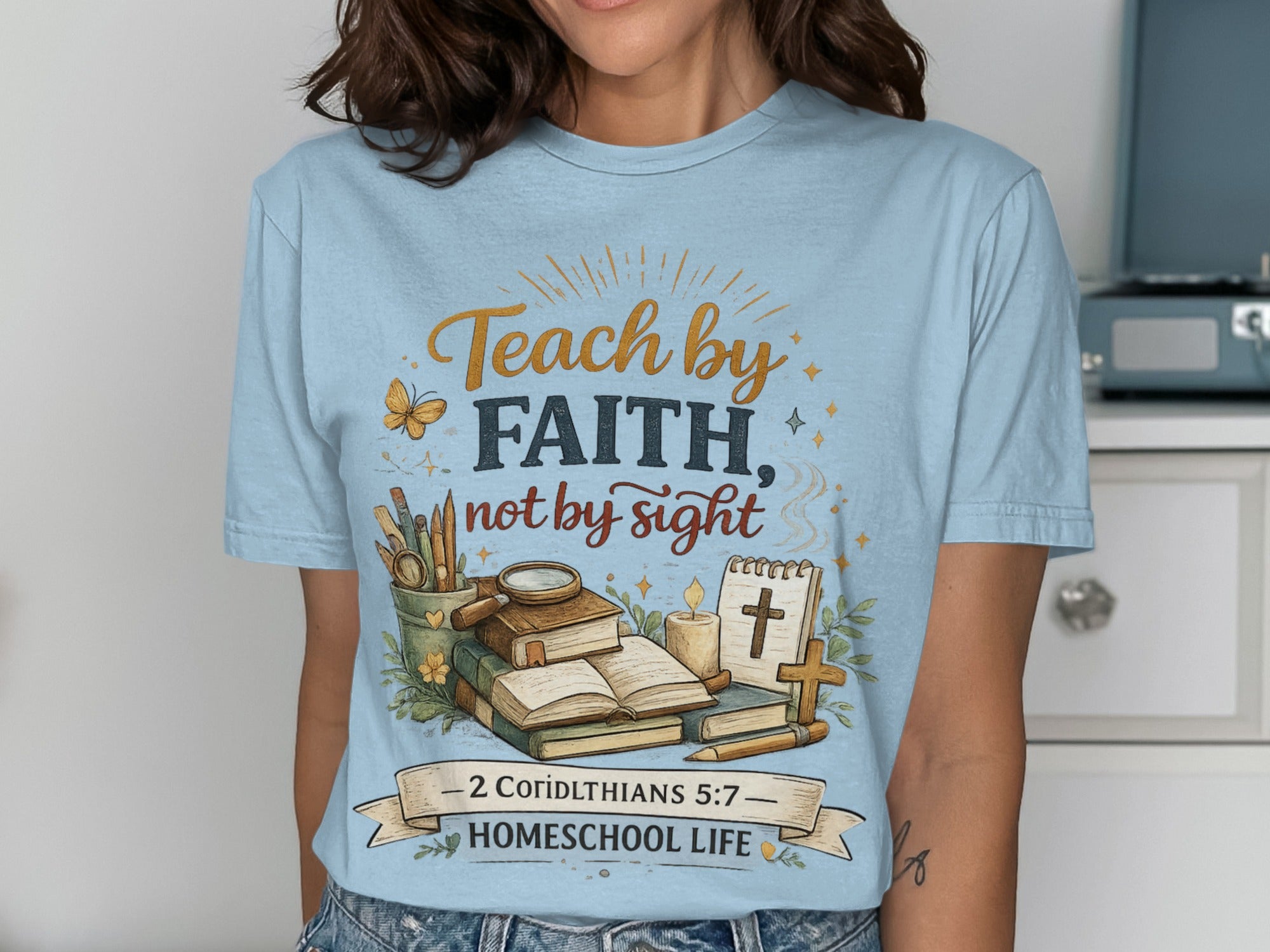 Light blue t-shirt with "Teach by Faith, not by sight" and "2 Corinthians 5:7" text.
