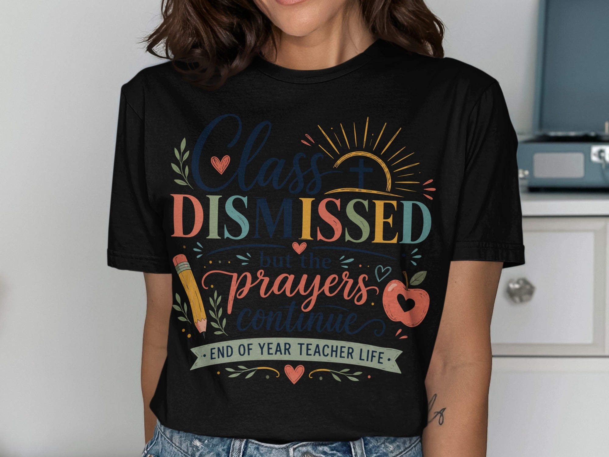 Black t-shirt with "Class Dismissed but the prayers continue END OF YEAR TEACHER LIFE" text.