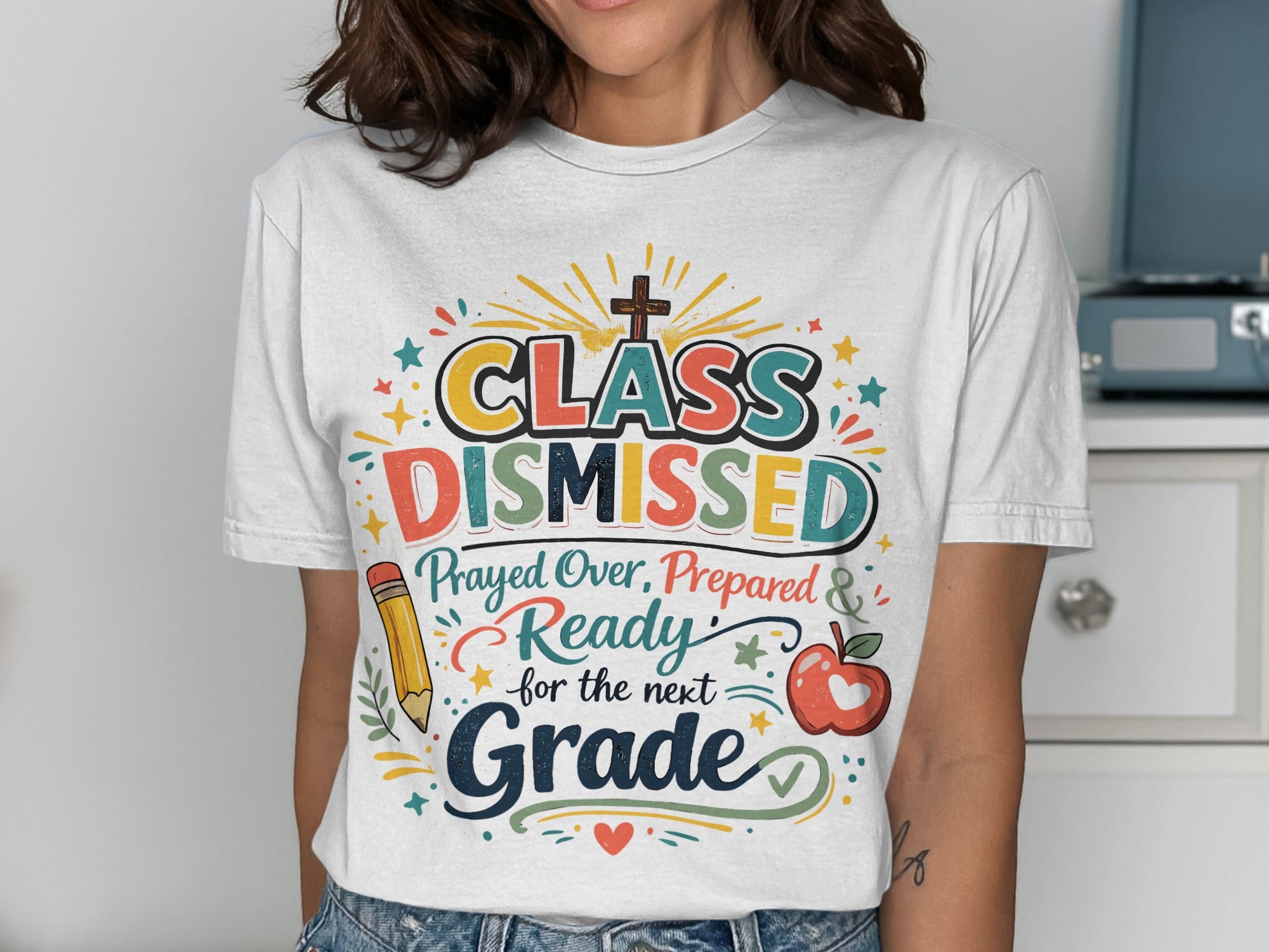 T-shirt with "Class Dismissed" text, cross, apple, and pencil graphic.