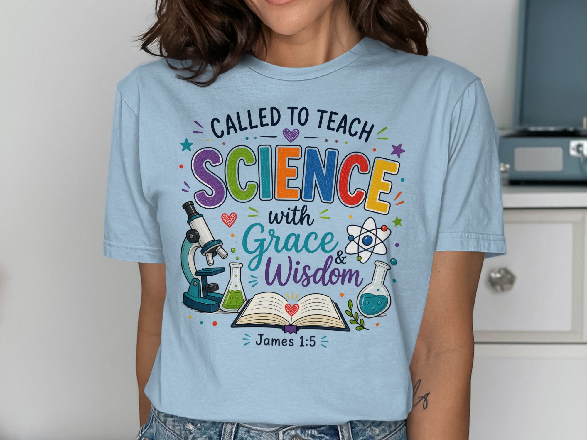 T-shirt with "Called to Teach Science with Grace & Wisdom" text, Bible verse, and science icons.