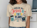 Cream t-shirt with text "Fueled by Jesus & Lesson Plans Teacher Life."