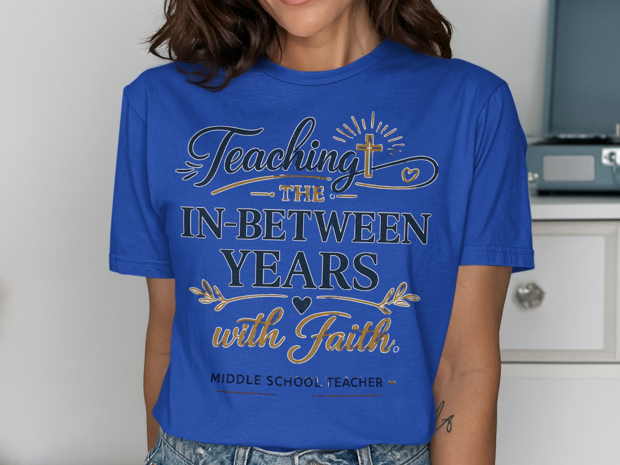 Blue t-shirt with "Teaching the in-between years with faith. Middle School Teacher." text.