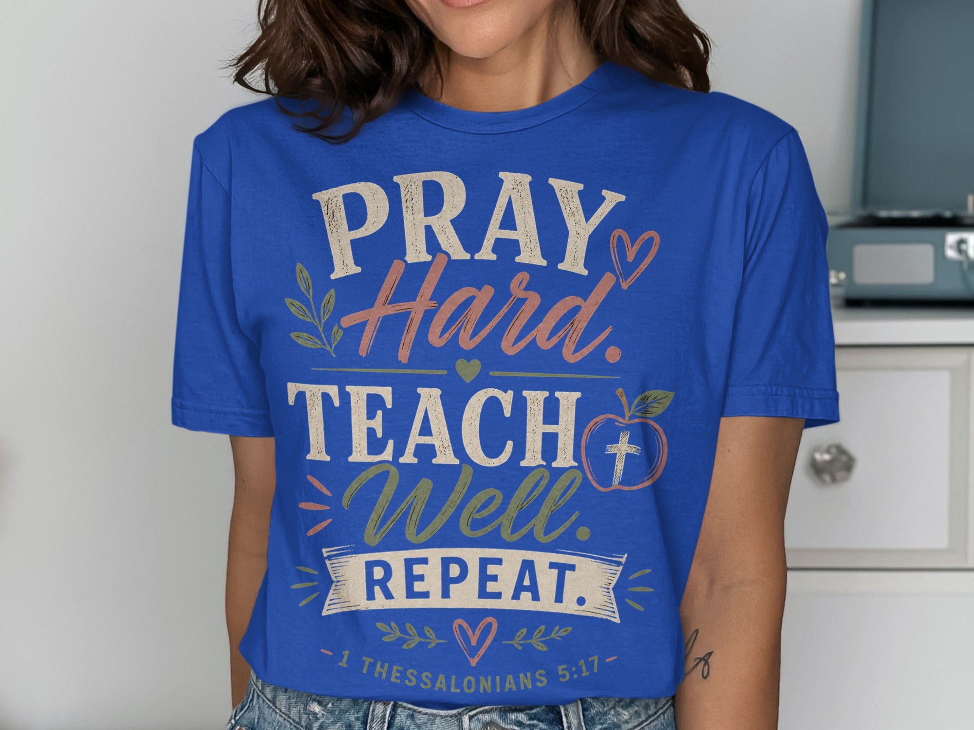Blue t-shirt with "PRAY Hard. TEACH Well. REPEAT. - 1 THESSALONIANS 5:17 -" text.