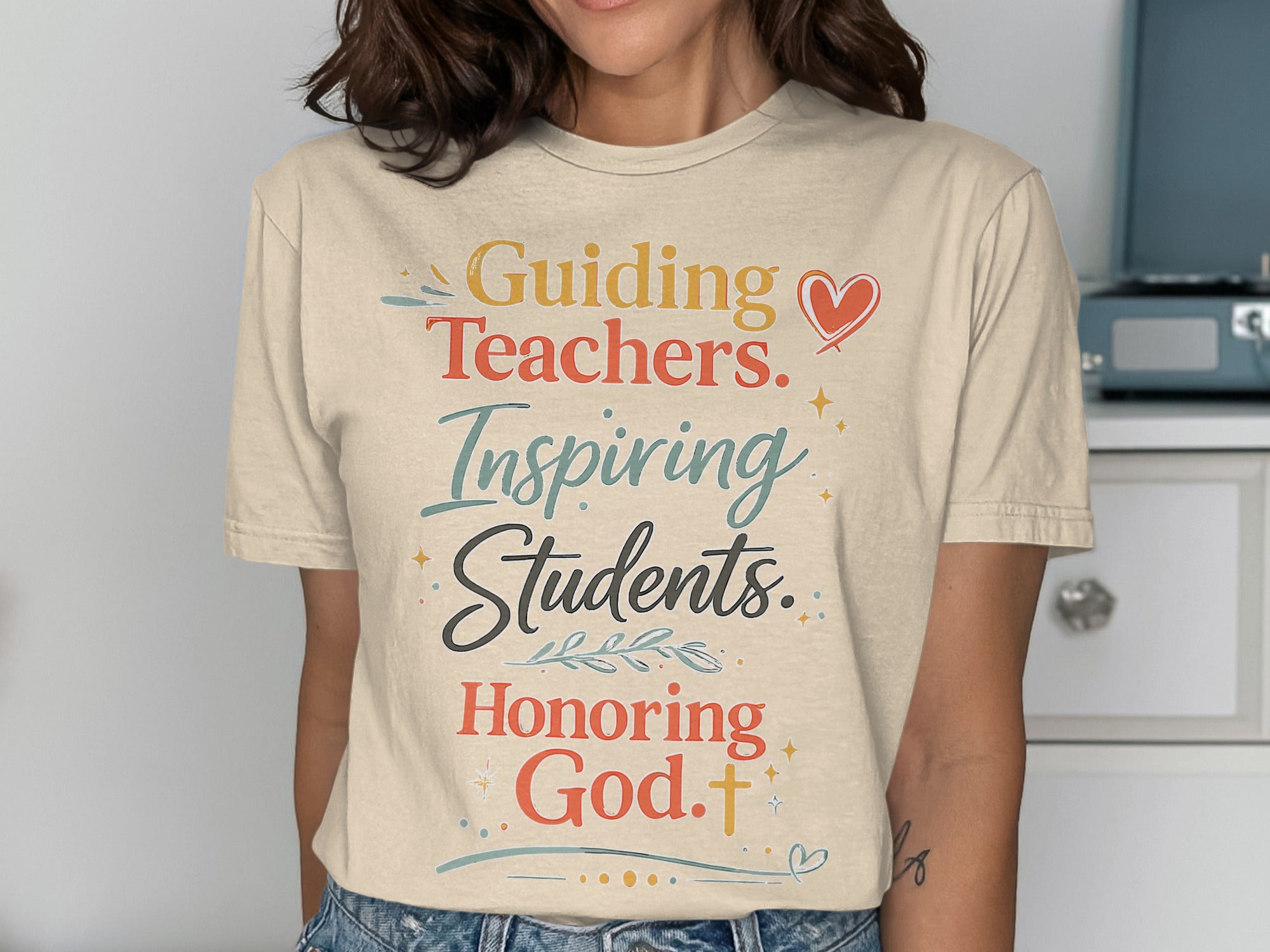 T-shirt with text "Guiding Teachers. Inspiring Students. Honoring God."