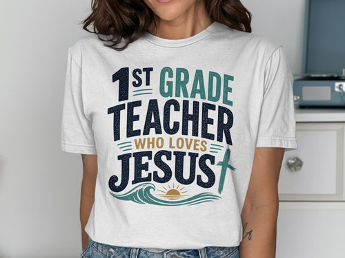 White t-shirt with "1st GRADE TEACHER WHO LOVES JESUS" text and cross design.