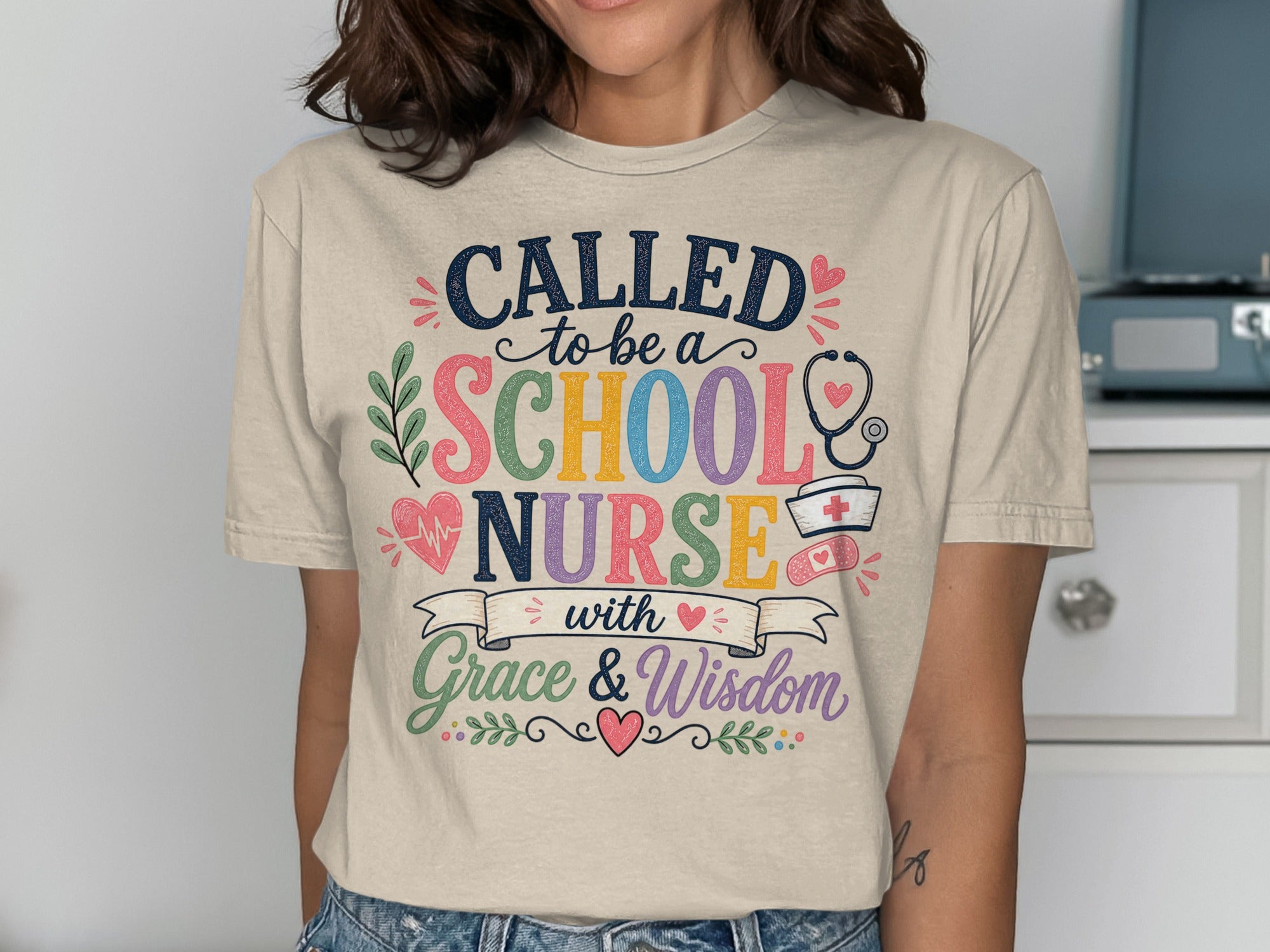T-shirt with "Called to be a School Nurse with Grace & Wisdom" text and medical graphics.