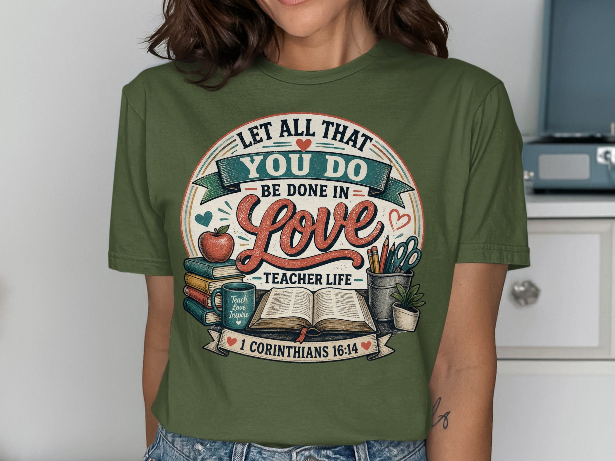 Green t-shirt with "Let All That You Do Be Done in Love Teacher Life" and Bible verse.