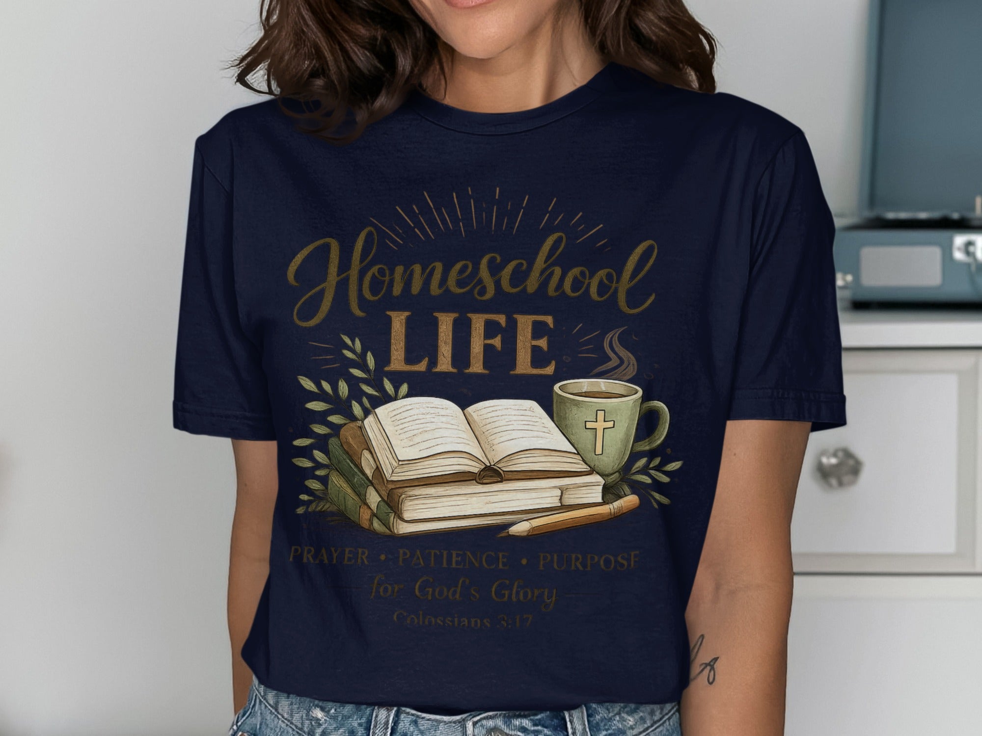 Navy t-shirt with "Homeschool Life" text, open book, mug, and Bible verse.
