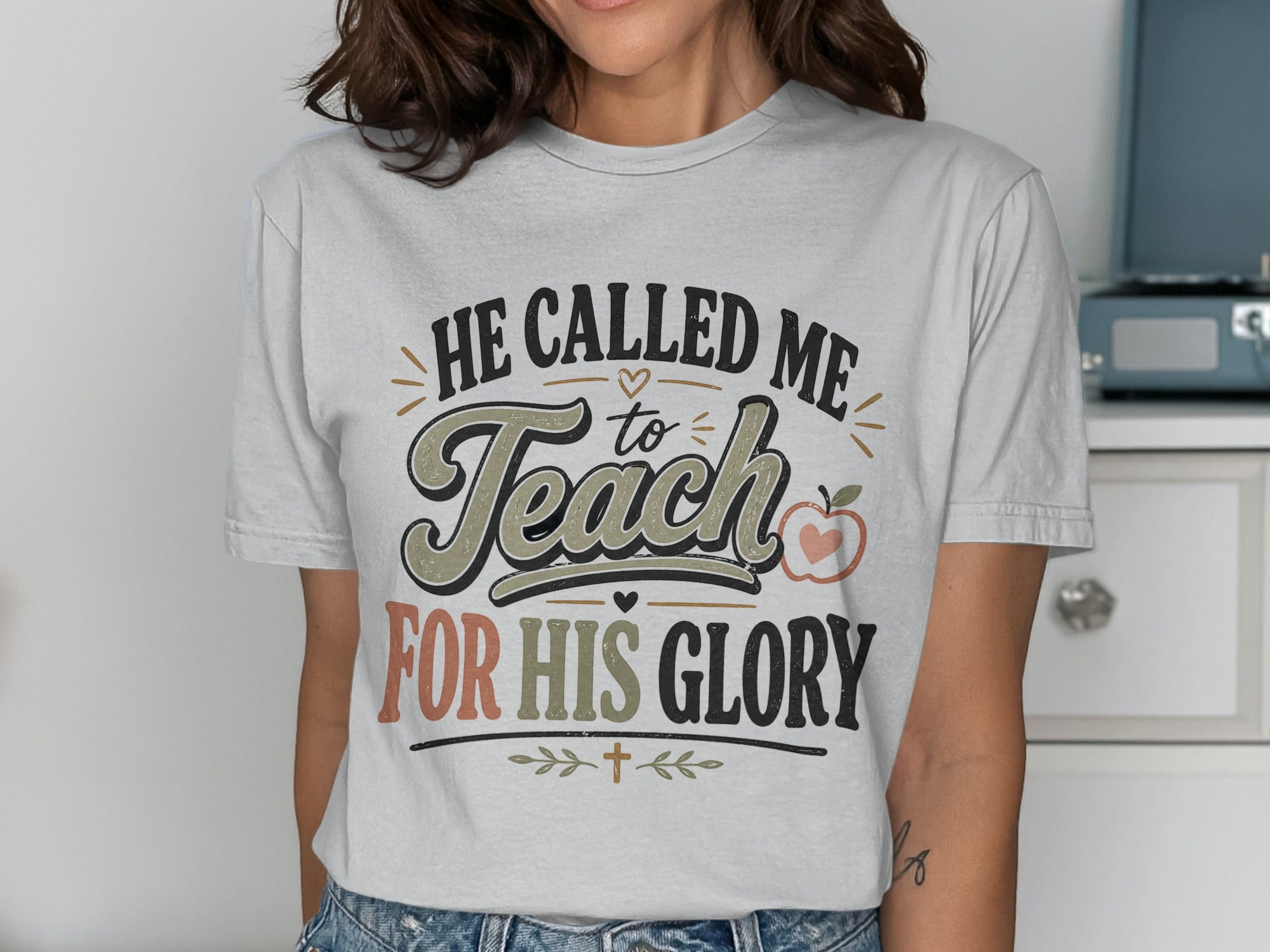 T-shirt with "He Called Me to Teach for His Glory" text and apple graphic.