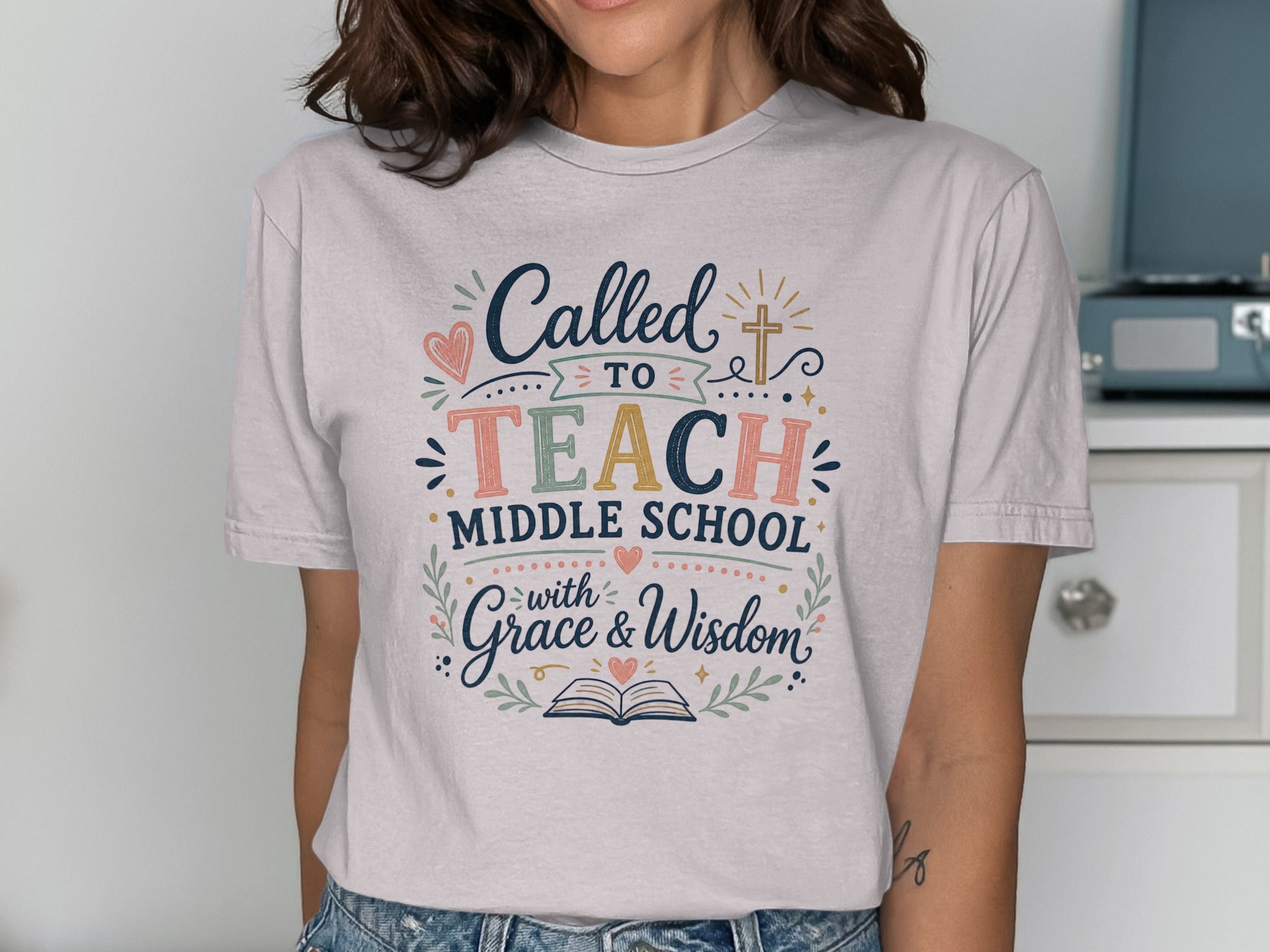 T-shirt with "Called to Teach Middle School with Grace & Wisdom" text and cross.