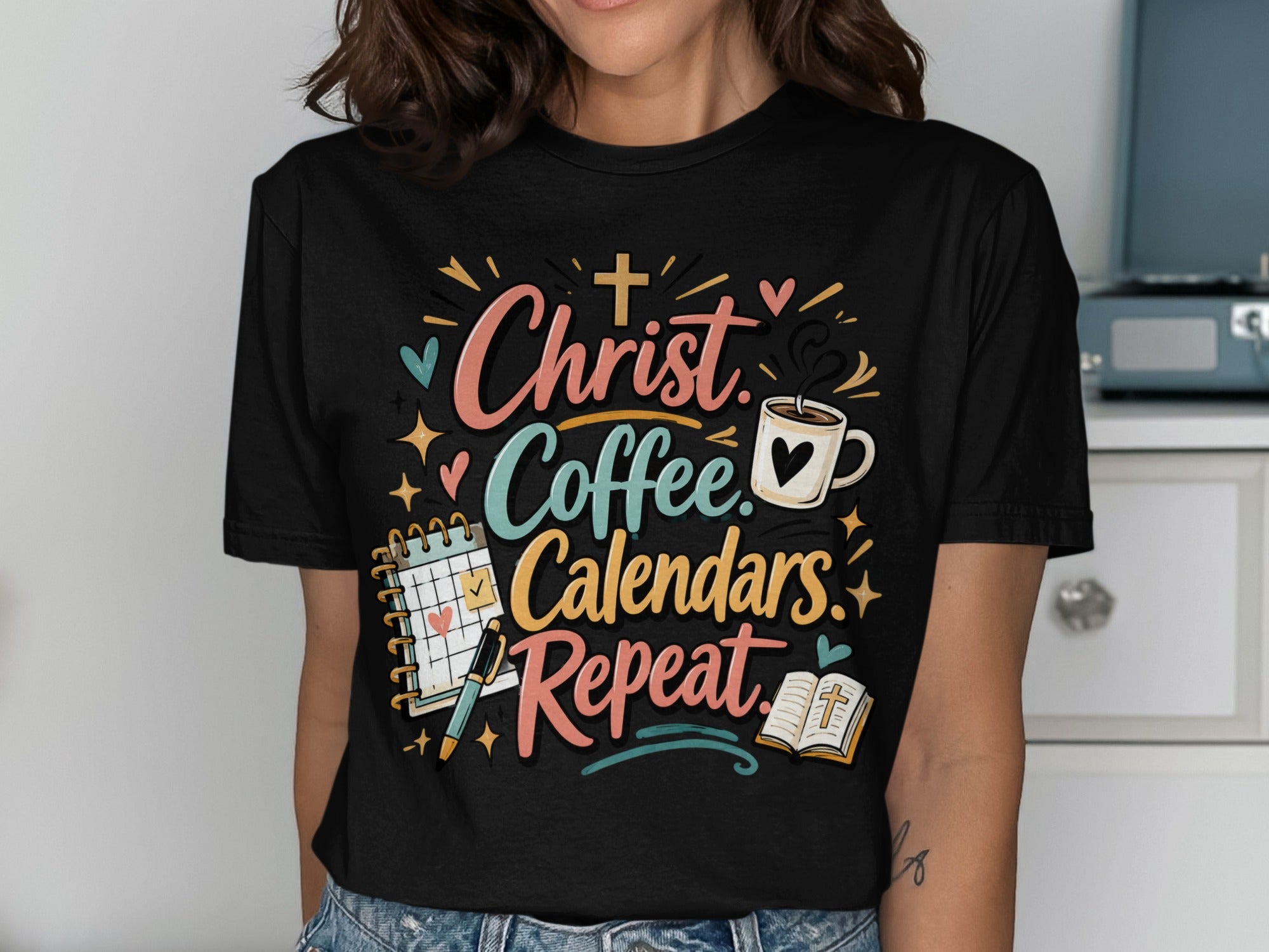 Black t-shirt with "Christ Coffee Calendars. Repeat." text and religious icons.