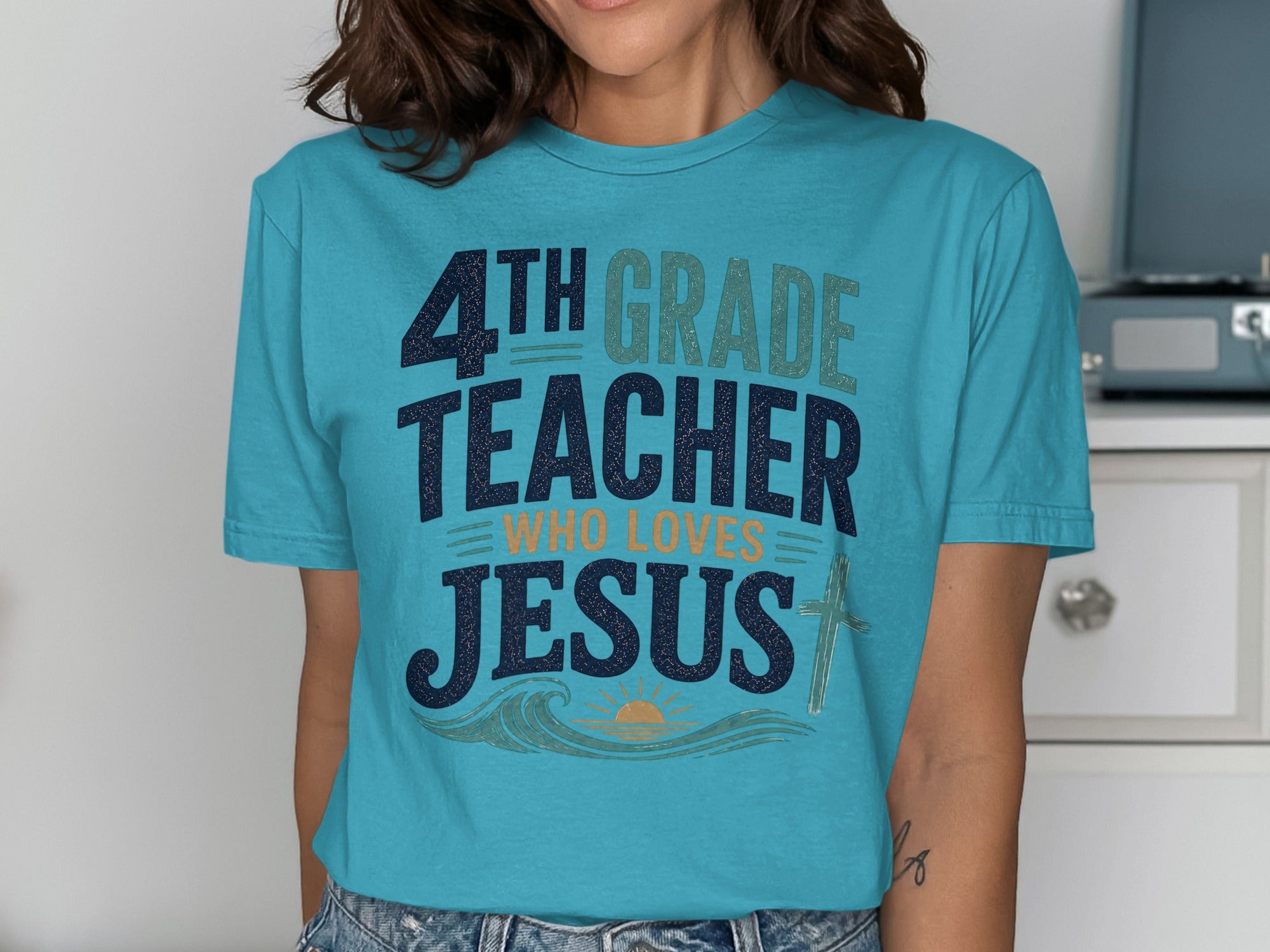 4th Grade Teacher Who Loves Jesus graphic tee with sun and cross.