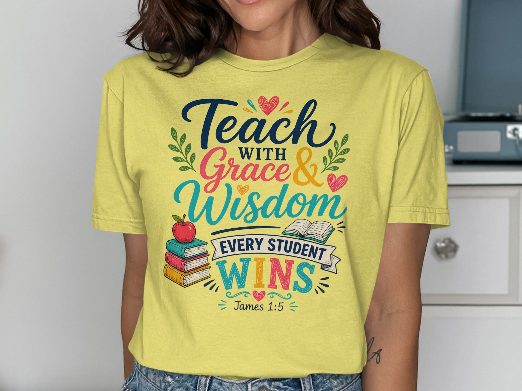 Yellow t-shirt with "Teach with Grace & Wisdom Every Student Wins" text and apple.