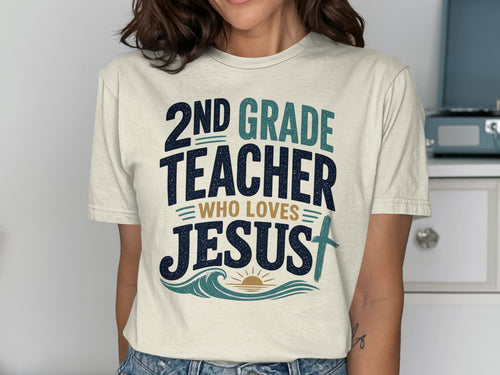 "2nd Grade Teacher Who Loves Jesus" text on a cream t-shirt with a cross.