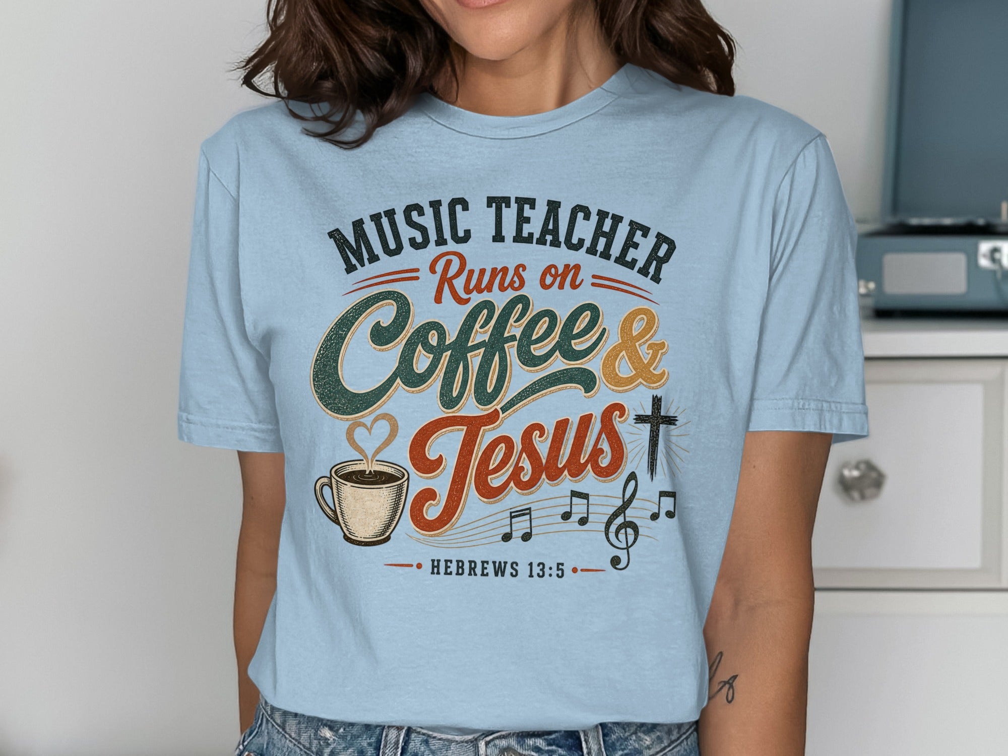 Light blue t-shirt with "Music Teacher Runs on Coffee & Jesus" and musical notes.