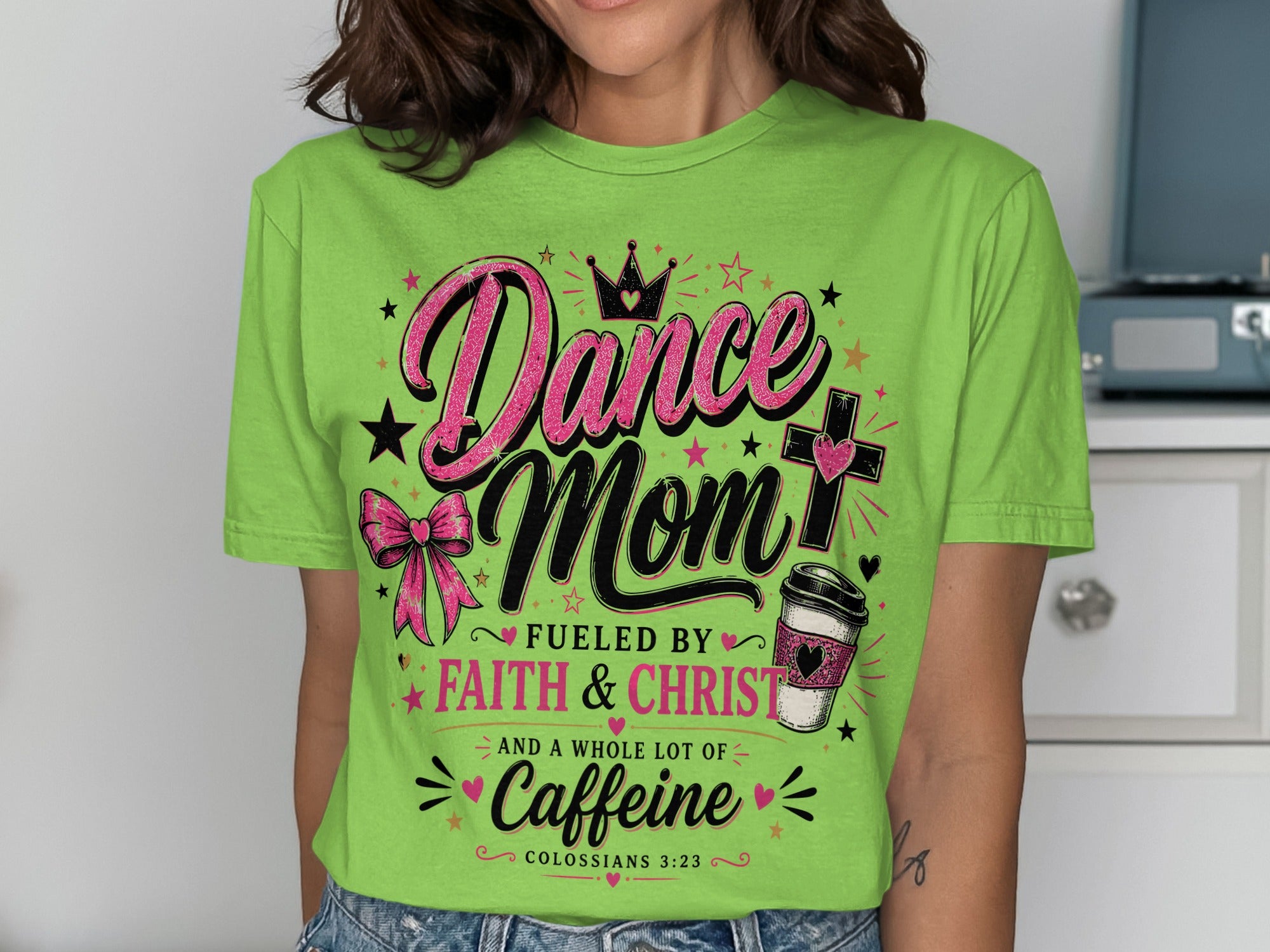 Green t-shirt with "Dance Mom Fueled by Faith & Christ and a Whole Lot of Caffeine" text.