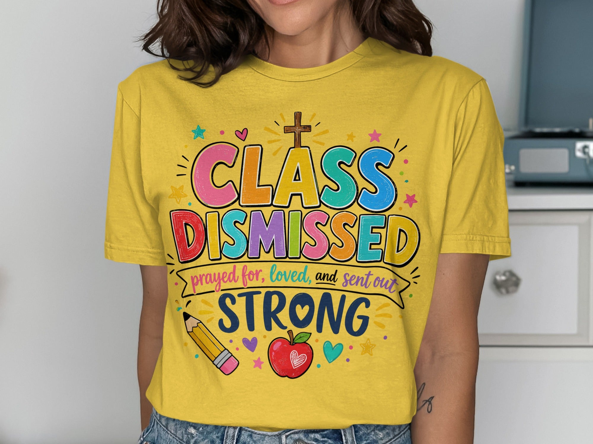 Yellow t-shirt with "CLASS DISMISSED" in colorful lettering and educational icons.