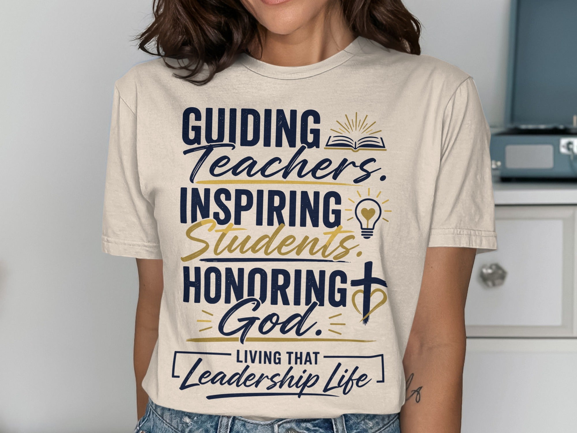 T-shirt with text "Guiding Teachers. Inspiring Students. Honoring God. Living That Leadership Life."