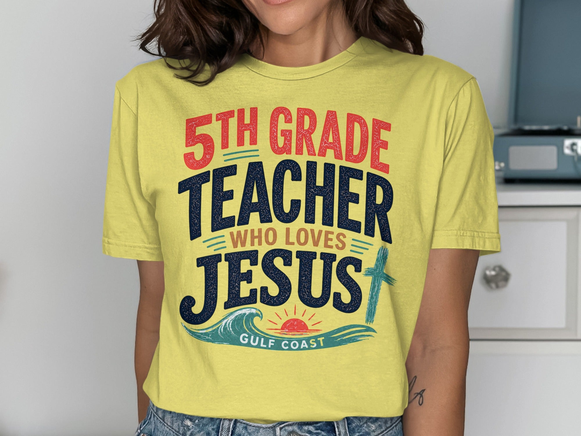 Yellow t-shirt with "5th Grade Teacher Who Loves Jesus" and a cross.