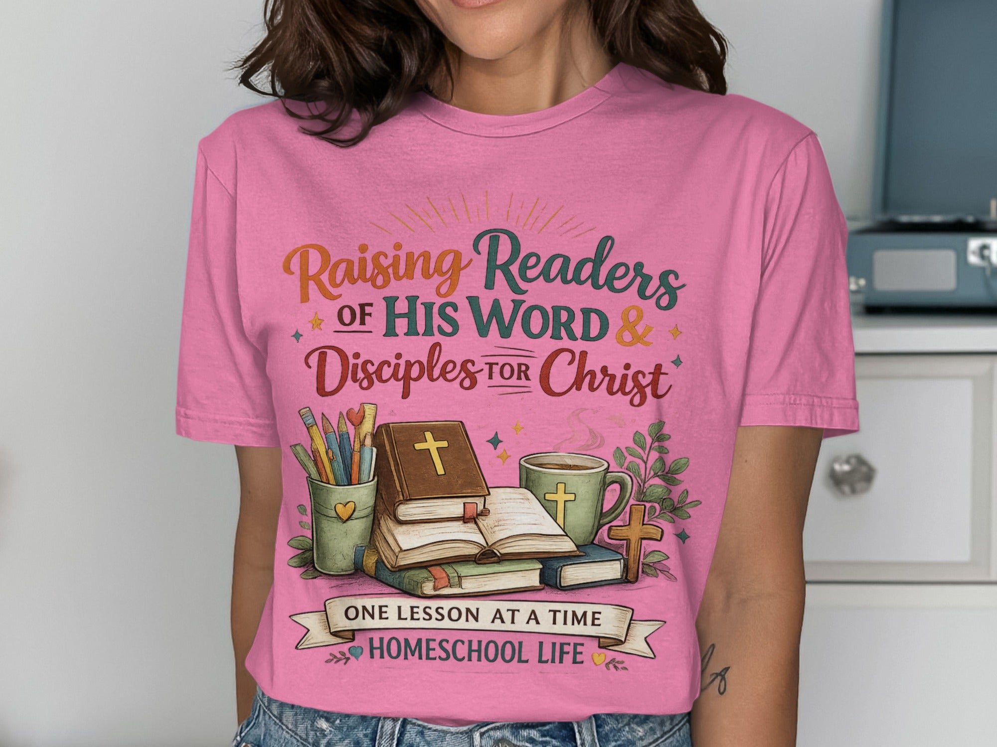 Pink t-shirt with "Raising Readers of His Word & Disciples for Christ" and homeschooling graphics.
