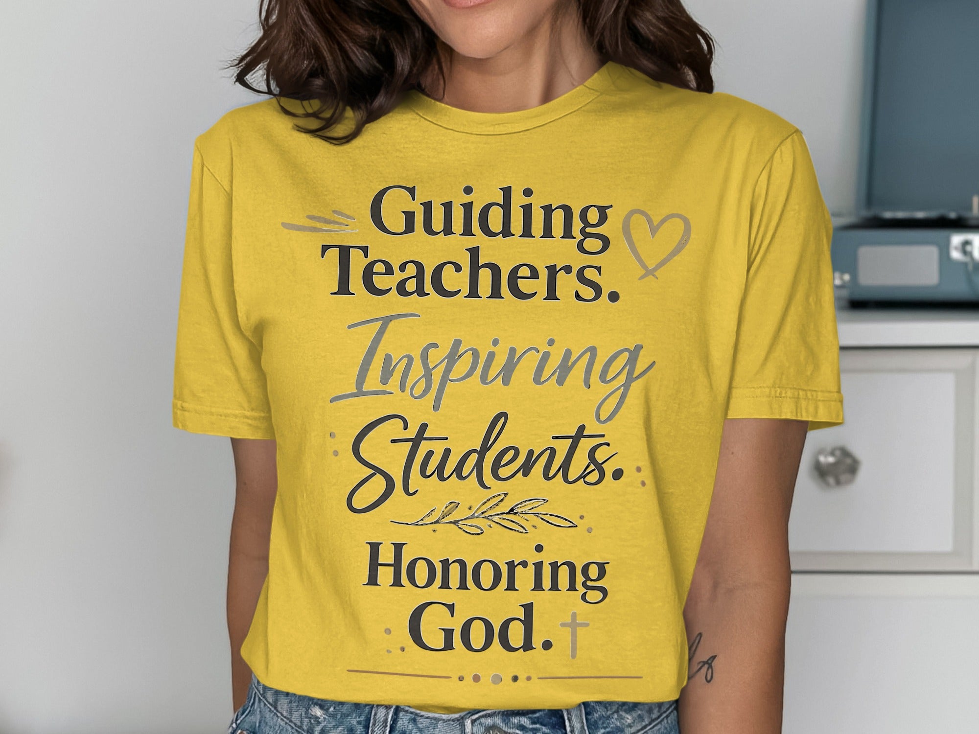 Yellow t-shirt with text "Guiding Teachers. Inspiring Students. Honoring God."