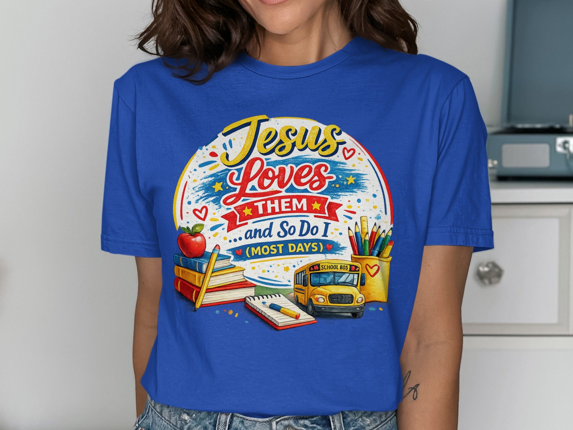 Jesus Loves Them and So Do I t-shirt with school supplies and a school bus.