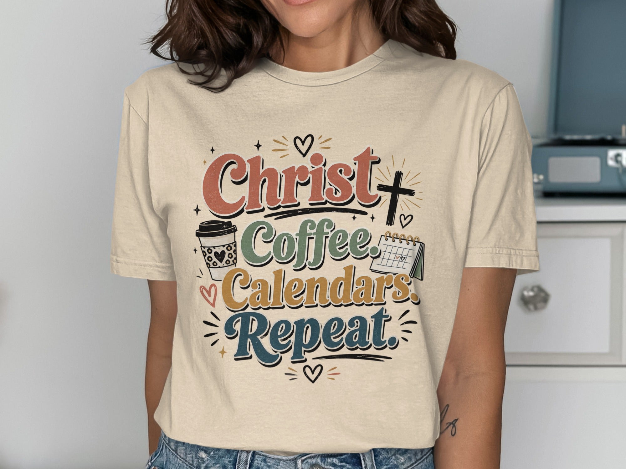 Cream t-shirt with "Christ Coffee Calendars Repeat" text and graphics.
