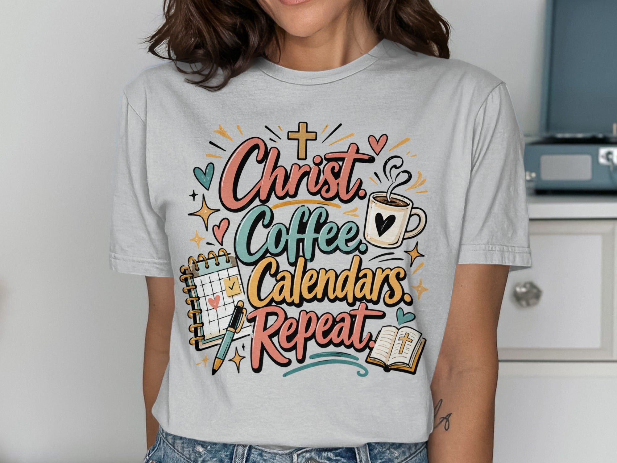 T-shirt with "Christ Coffee Calendars Repeat" and religious icons.