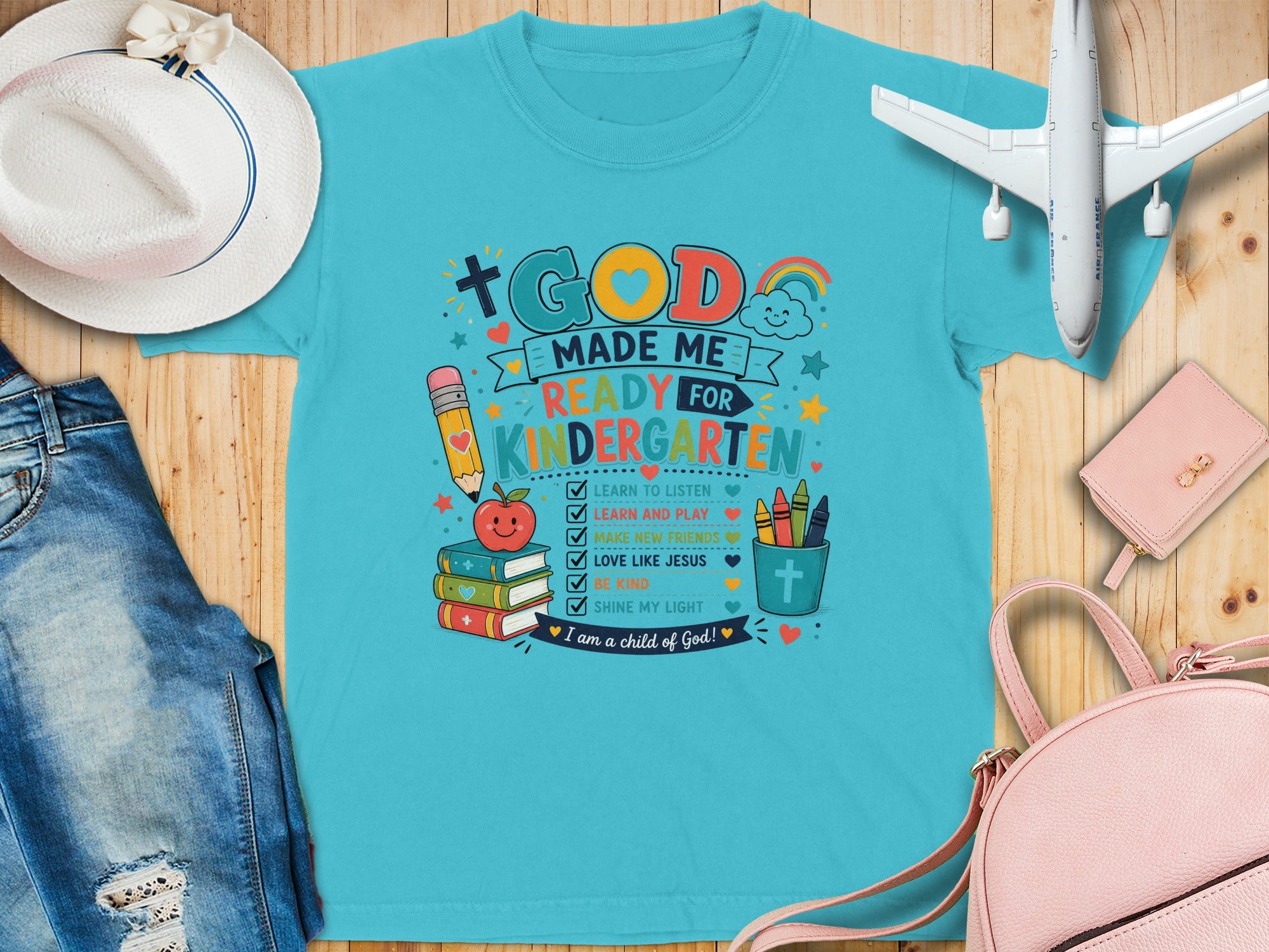 T-shirt with "God Made Me Ready for Kindergarten" and related icons.