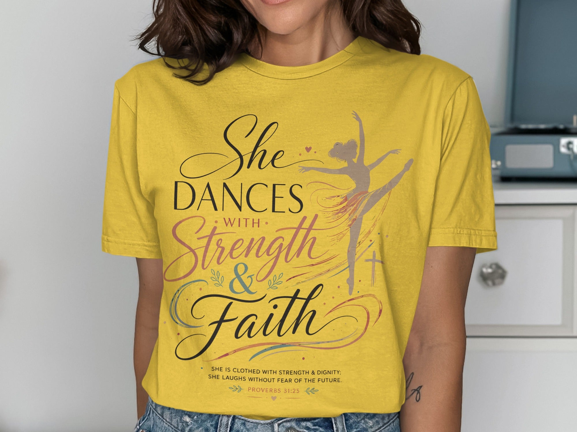 Yellow t-shirt with "She Dances with Strength & Faith" and Proverbs 31:25.