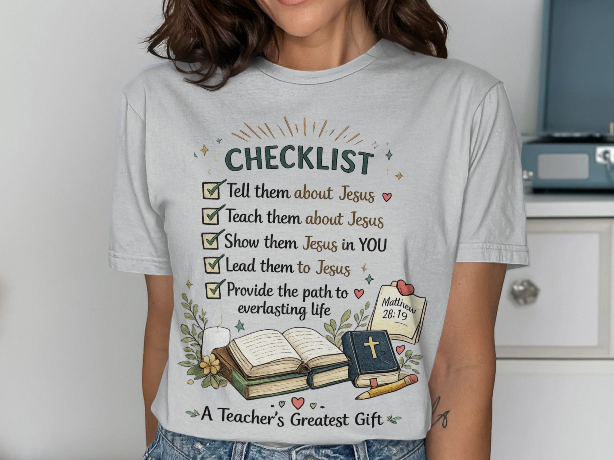 T-shirt with "CHECKLIST" and "A Teacher's Greatest Gift" text and Bible imagery.