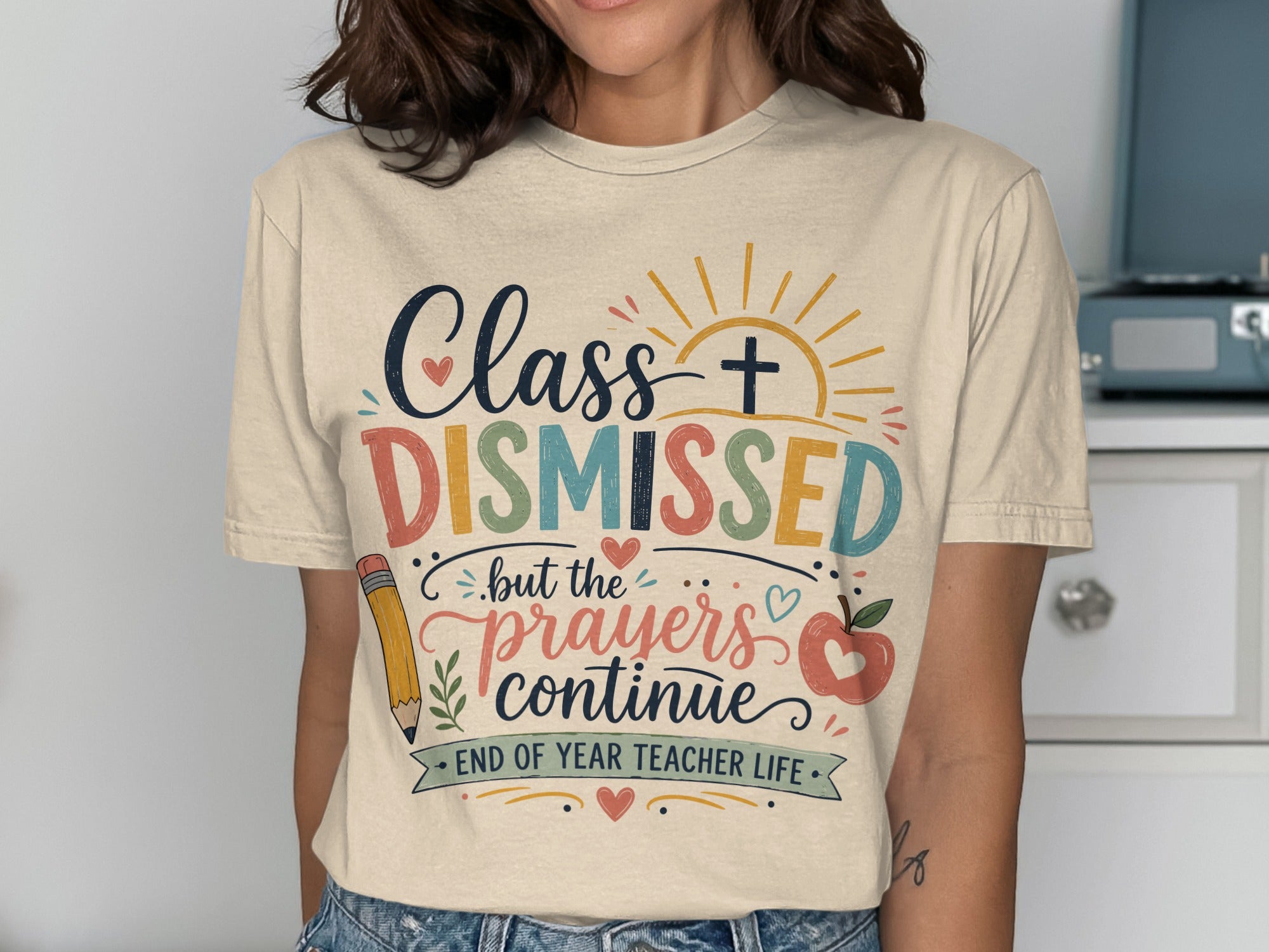 Teacher t-shirt with "Class DISMISSED but the prayers continue" and sun graphic.