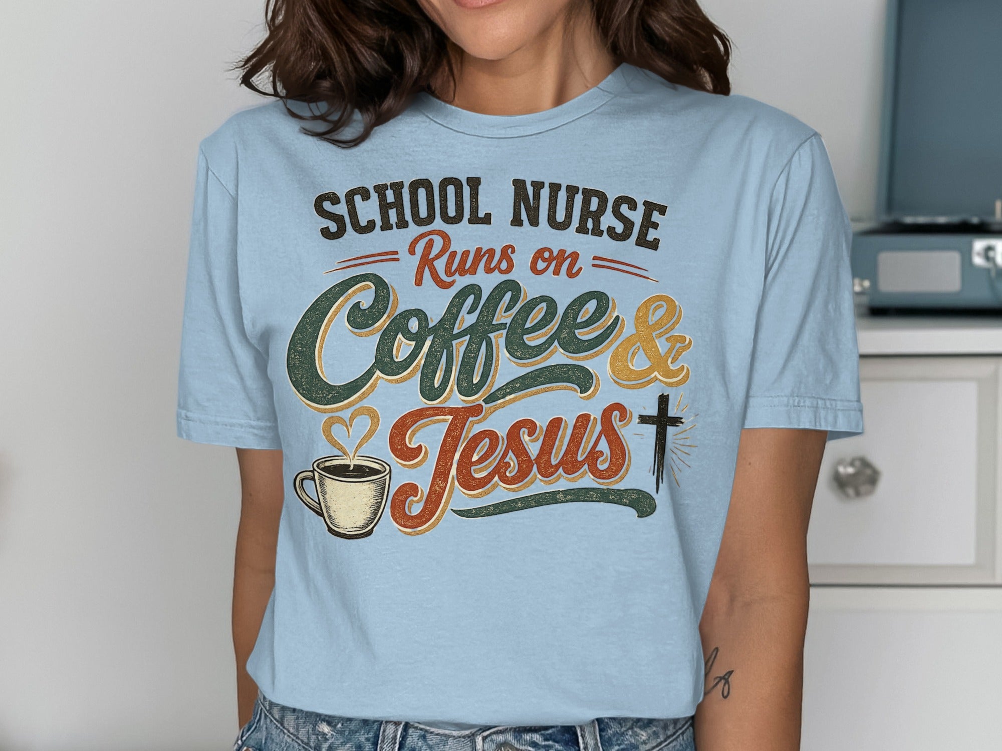 Light blue t-shirt with "School Nurse Runs on Coffee & Jesus" graphic.