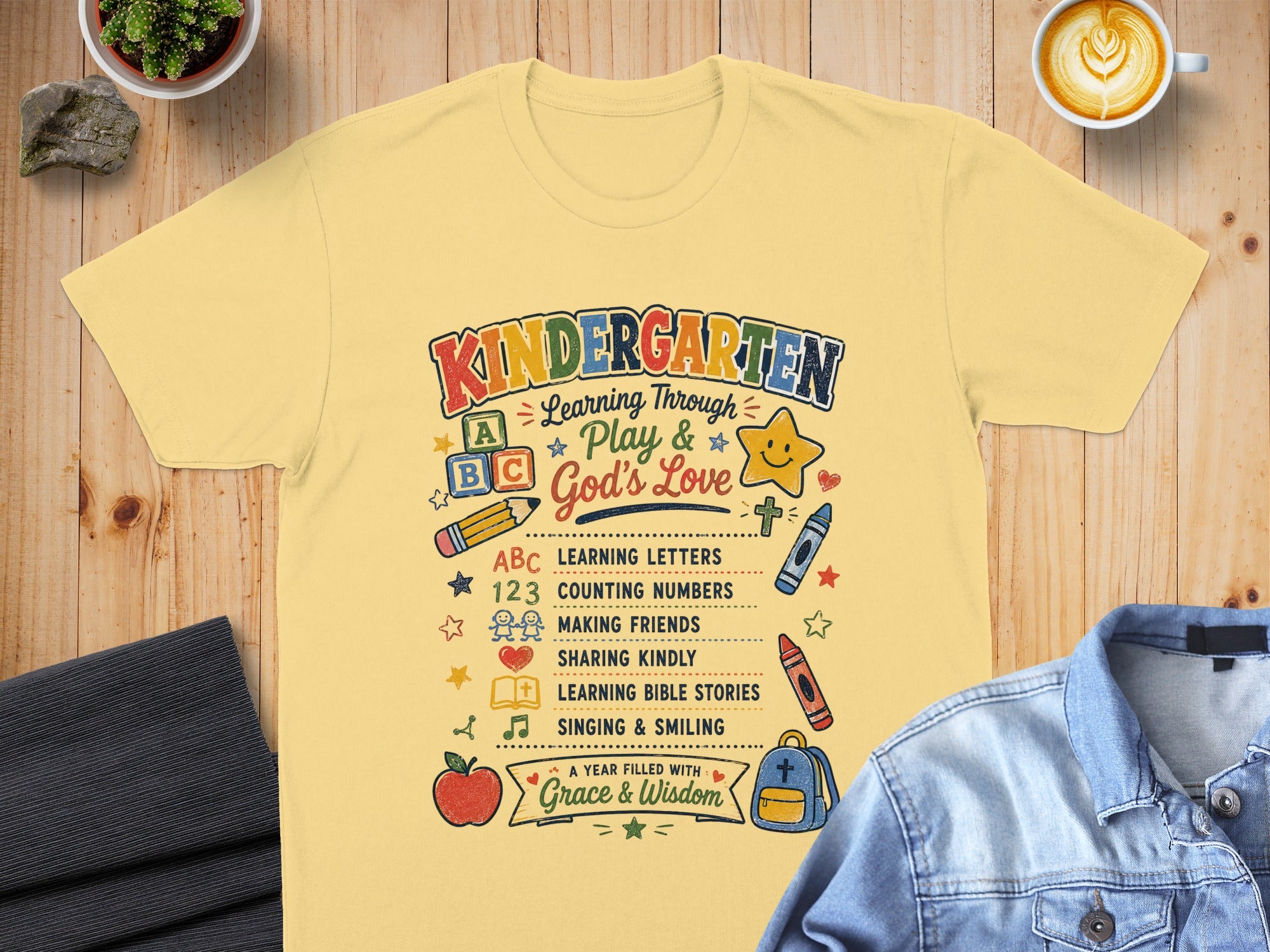 Kindergarten shirt with "Learning Through Play & God's Love" and school-related icons.