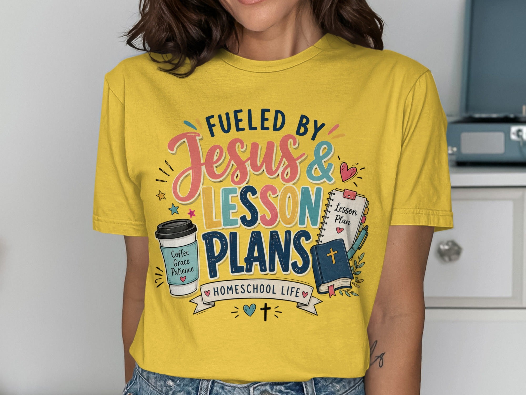 Yellow t-shirt with "Fueled by Jesus & Lesson Plans Homeschool Life" text.