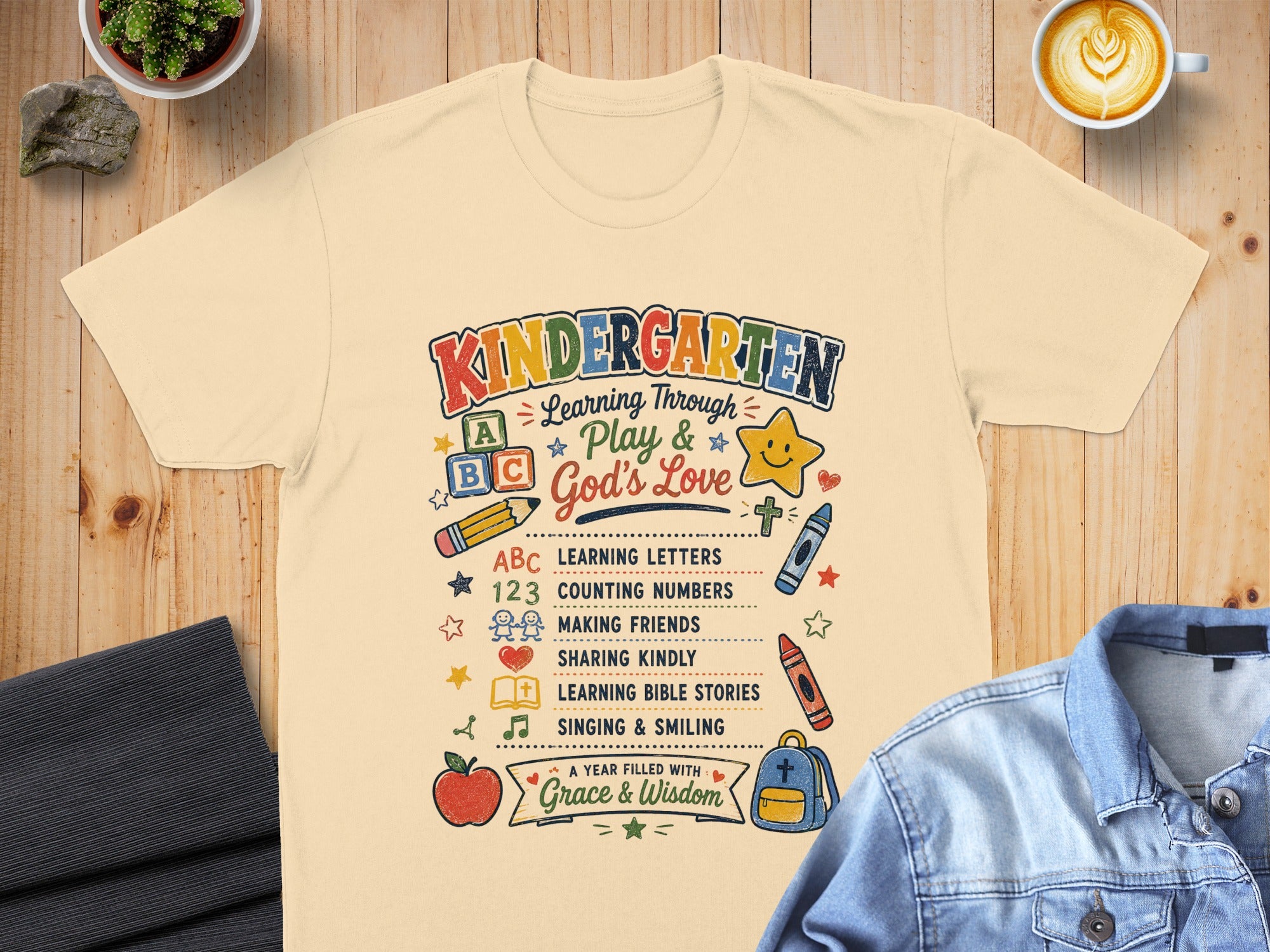 Kindergarten t-shirt with learning themes and "Grace & Wisdom" text.