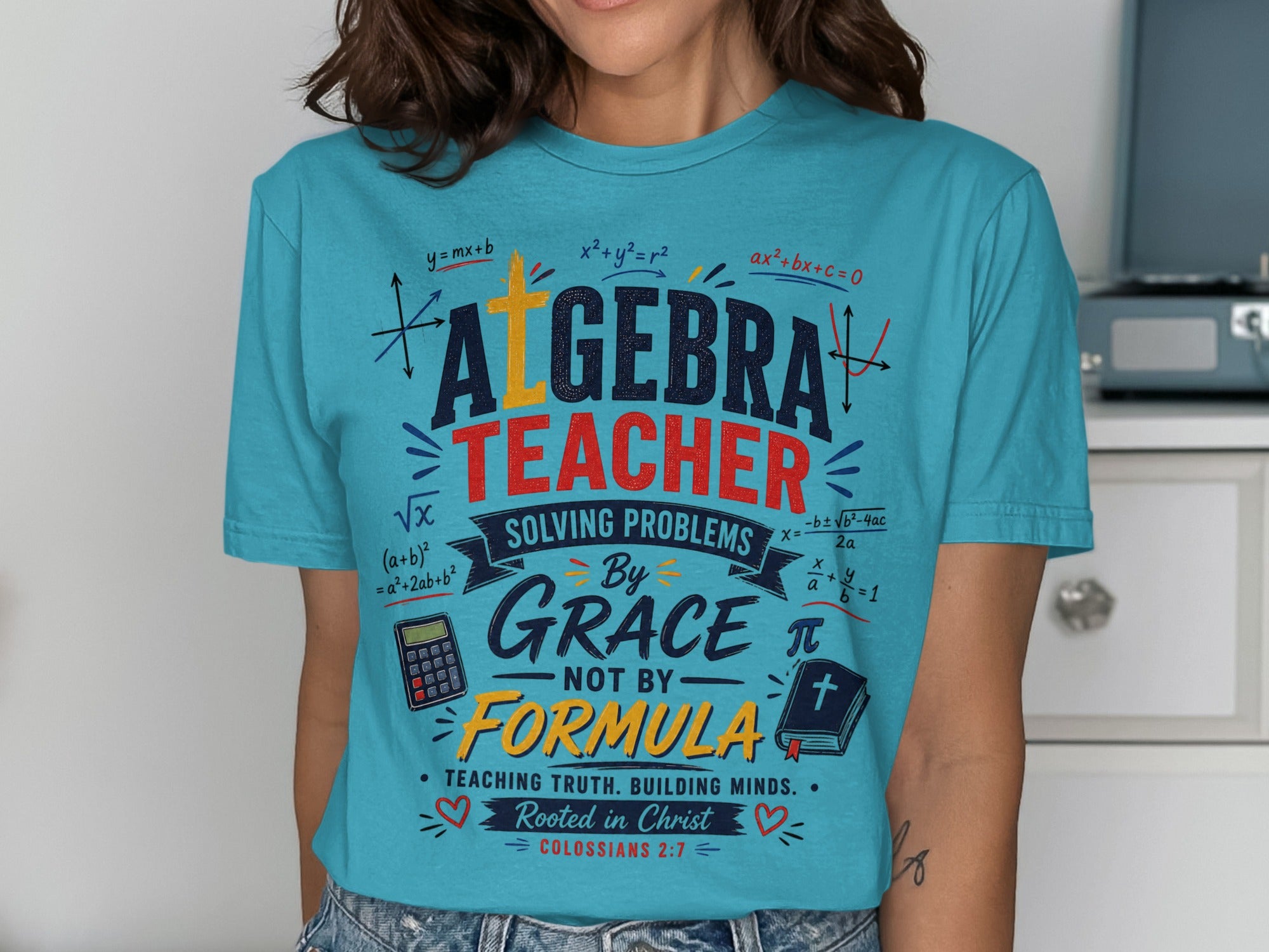 Turquoise t-shirt with "Algebra Teacher" and biblical verse.