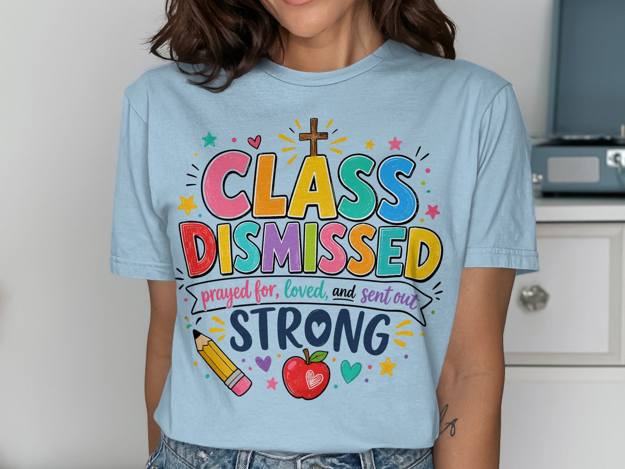 Light blue t-shirt with "Class Dismissed" and "prayed for, loved, and sent out STRONG" in colorful text.