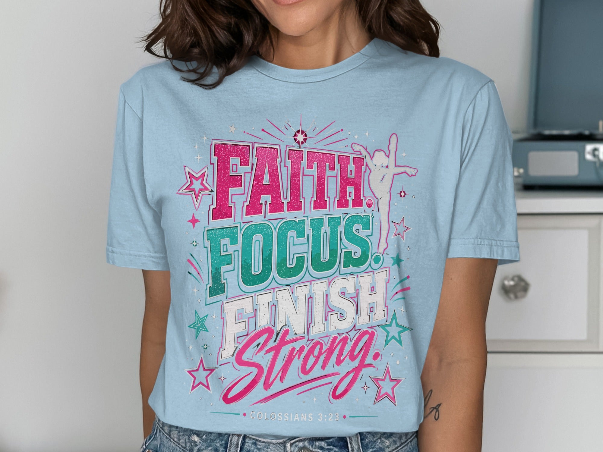Light blue t-shirt with "FAITH FOCUS FINISH STRONG" text and stars.