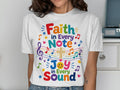 White t-shirt with "Faith in Every Note, Joy in Every Sound" text and music notes.