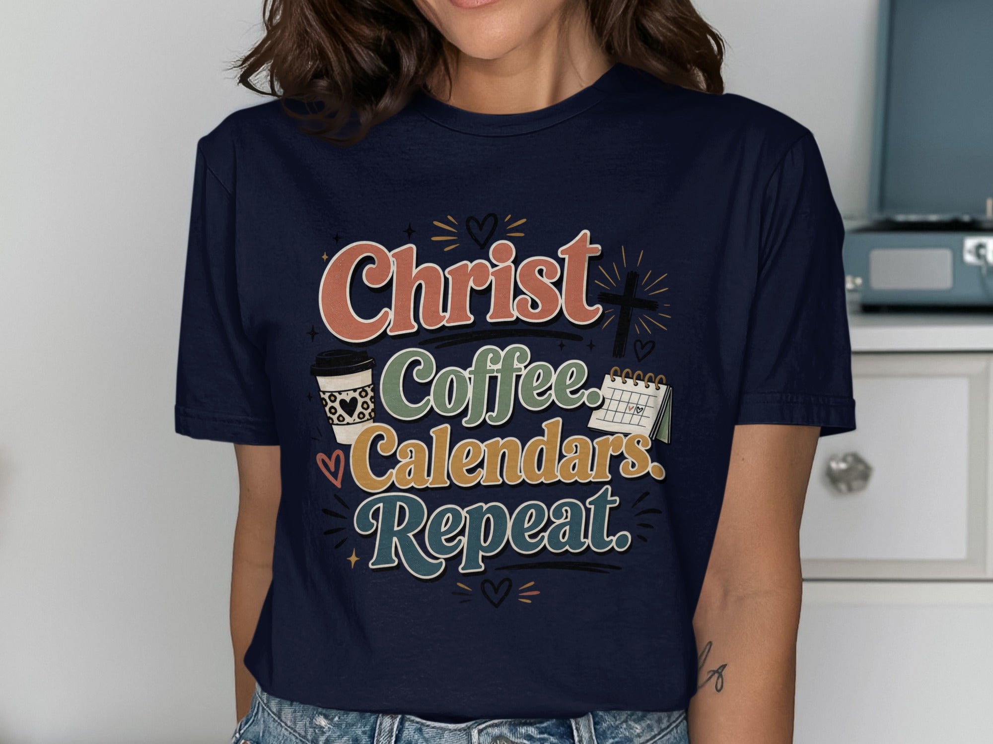 Navy t-shirt with "Christ. Coffee. Calendars. Repeat." and a cross graphic.
