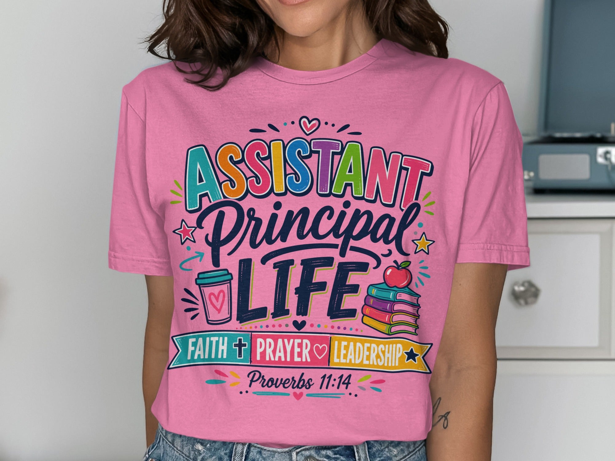 Pink t-shirt with "Assistant Principal Life" text and school-themed graphics.