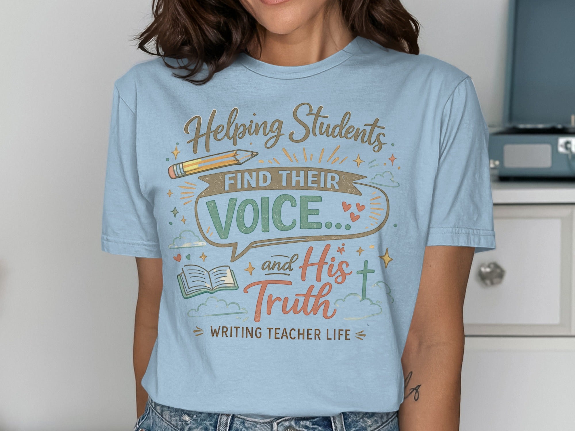 Light blue t-shirt with "Helping Students Find Their Voice and His Truth" text.