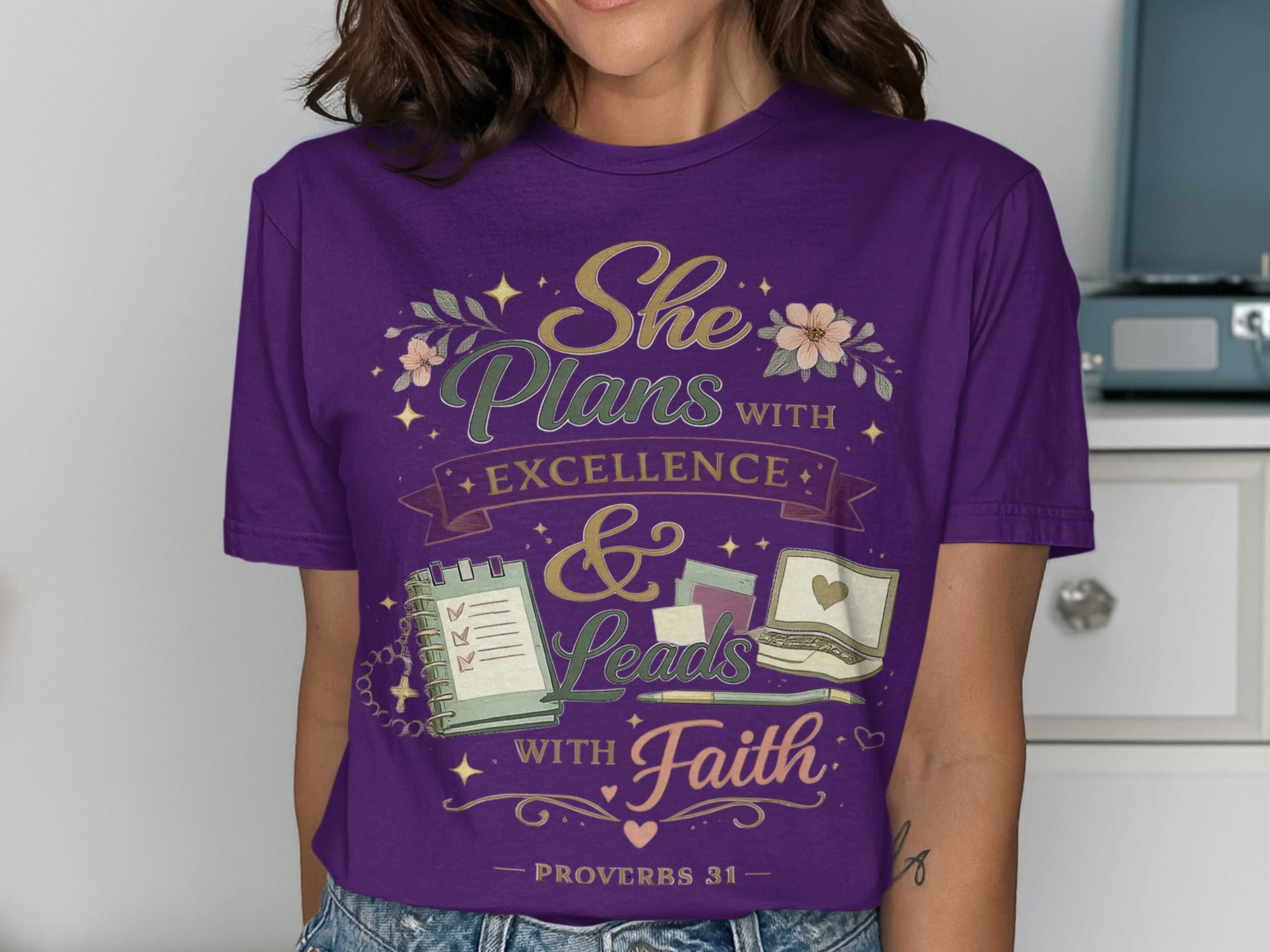Purple t-shirt with "She Plans with Excellence & Leads with Faith" text.