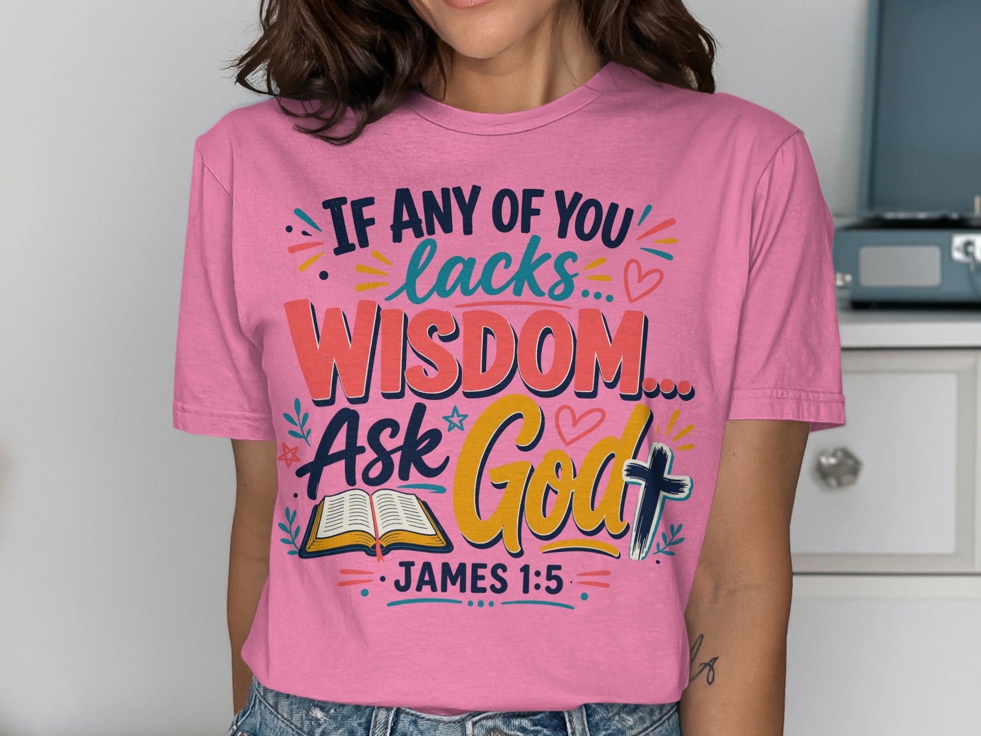 Pink t-shirt with "If any of you lacks wisdom, ask God" and "James 1:5".