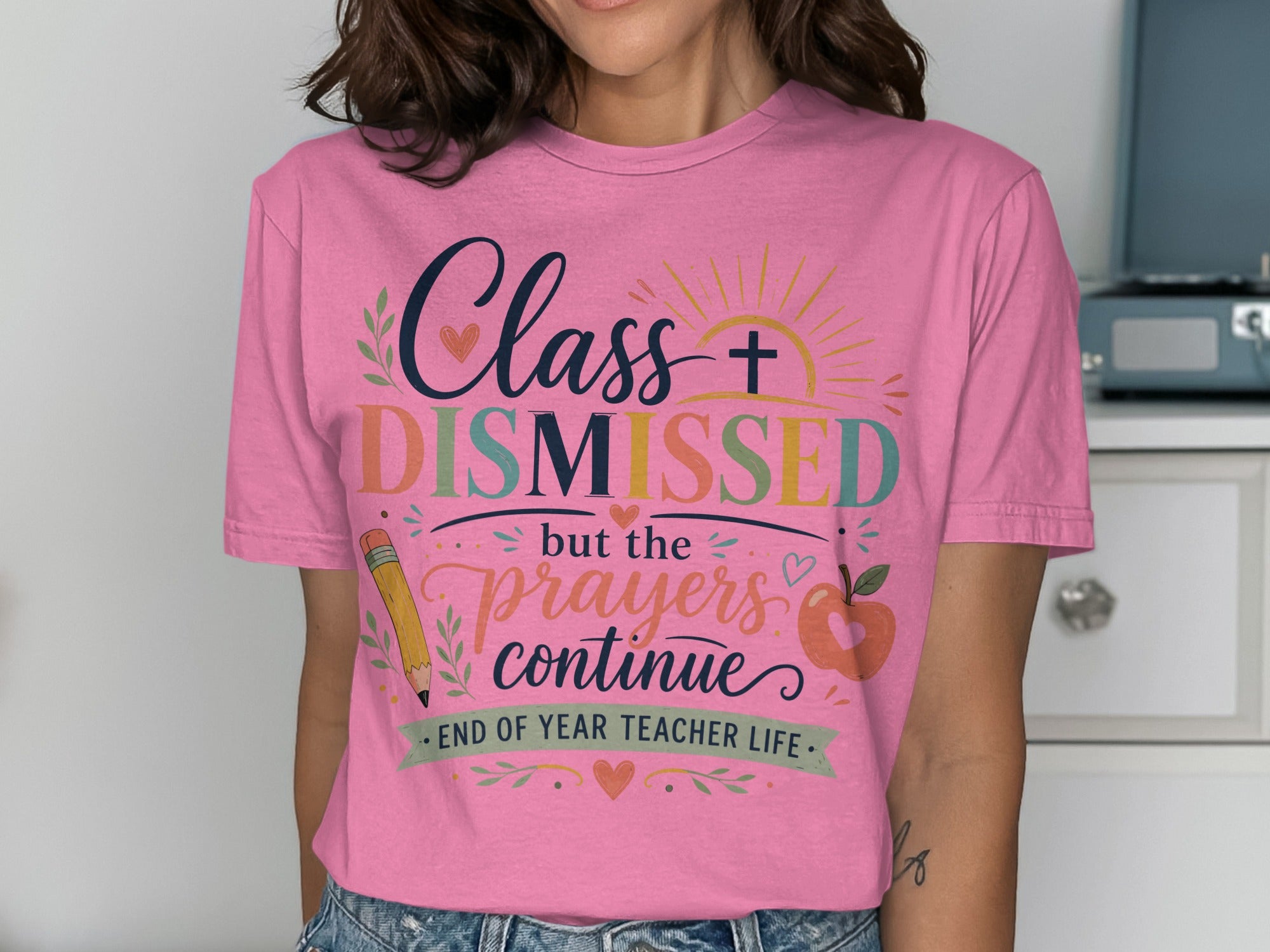Pink t-shirt with "Class Dismissed but the prayers continue" graphic.