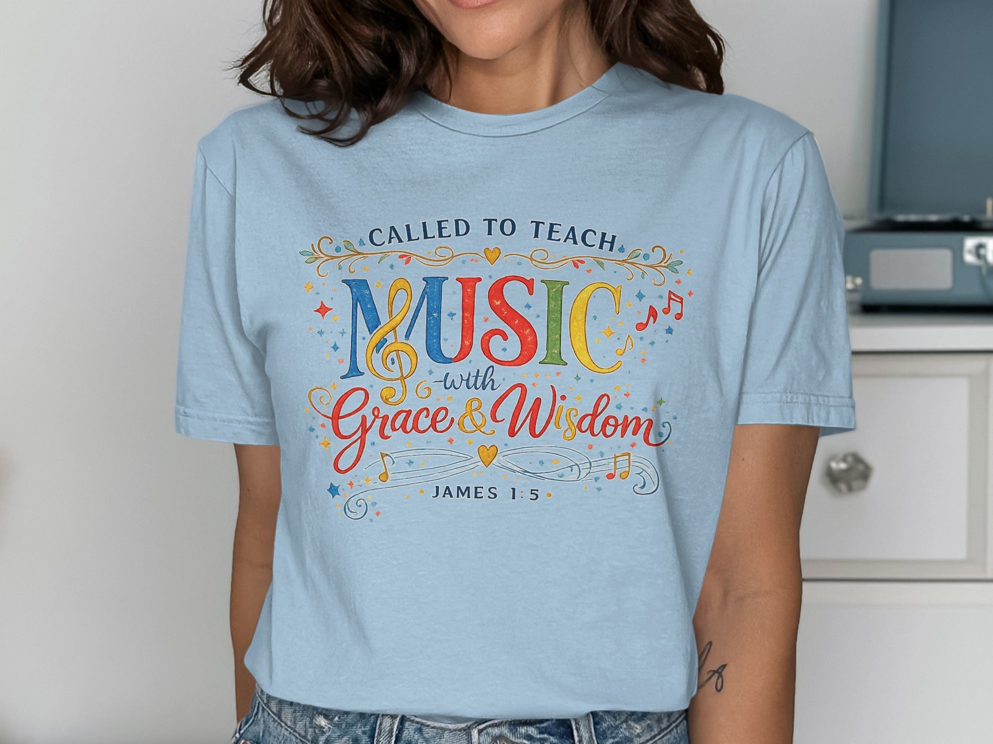 Light blue t-shirt with "Called to Teach Music with Grace & Wisdom" and James 1:5.